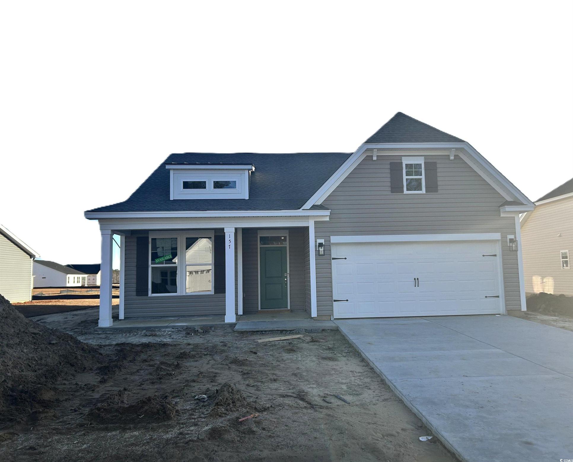 Exterior:View of front of property with a porch, driveway, a garage, and roof with shingles