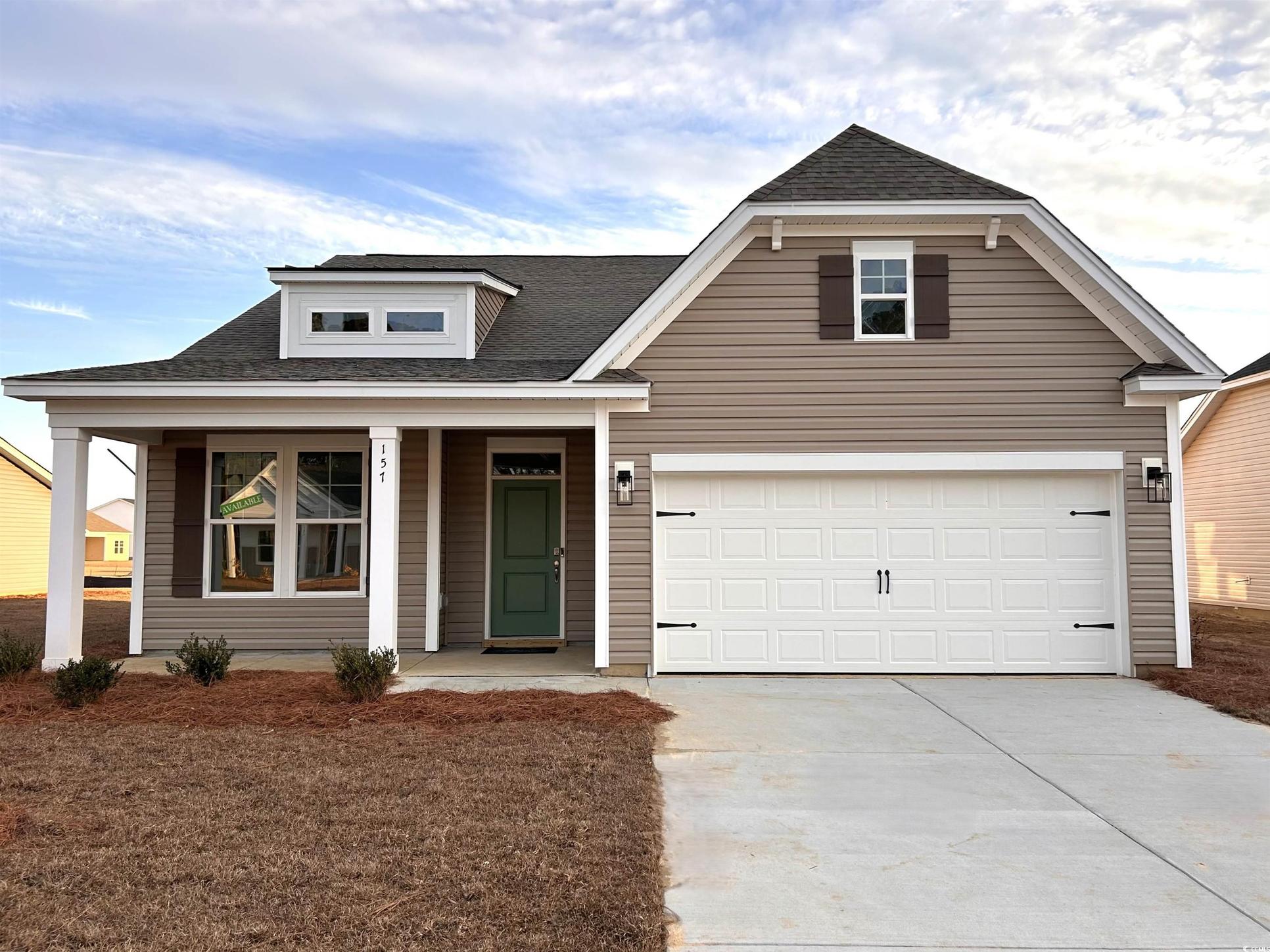 Exterior:View of front facade featuring covered porch, concrete driveway, and a shingled roof