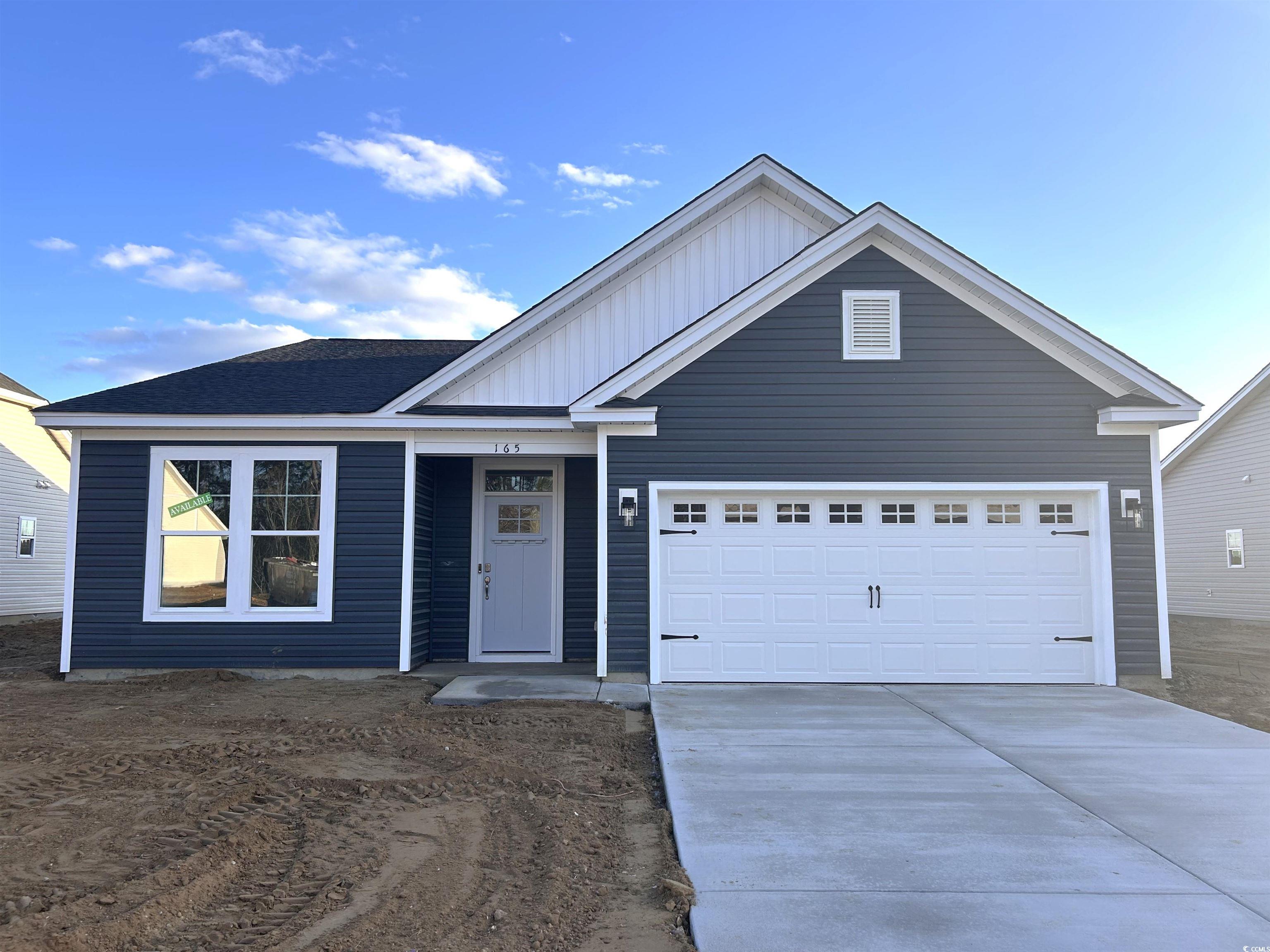 Exterior:Ranch-style home featuring board and batten siding, driveway, and an attached garage