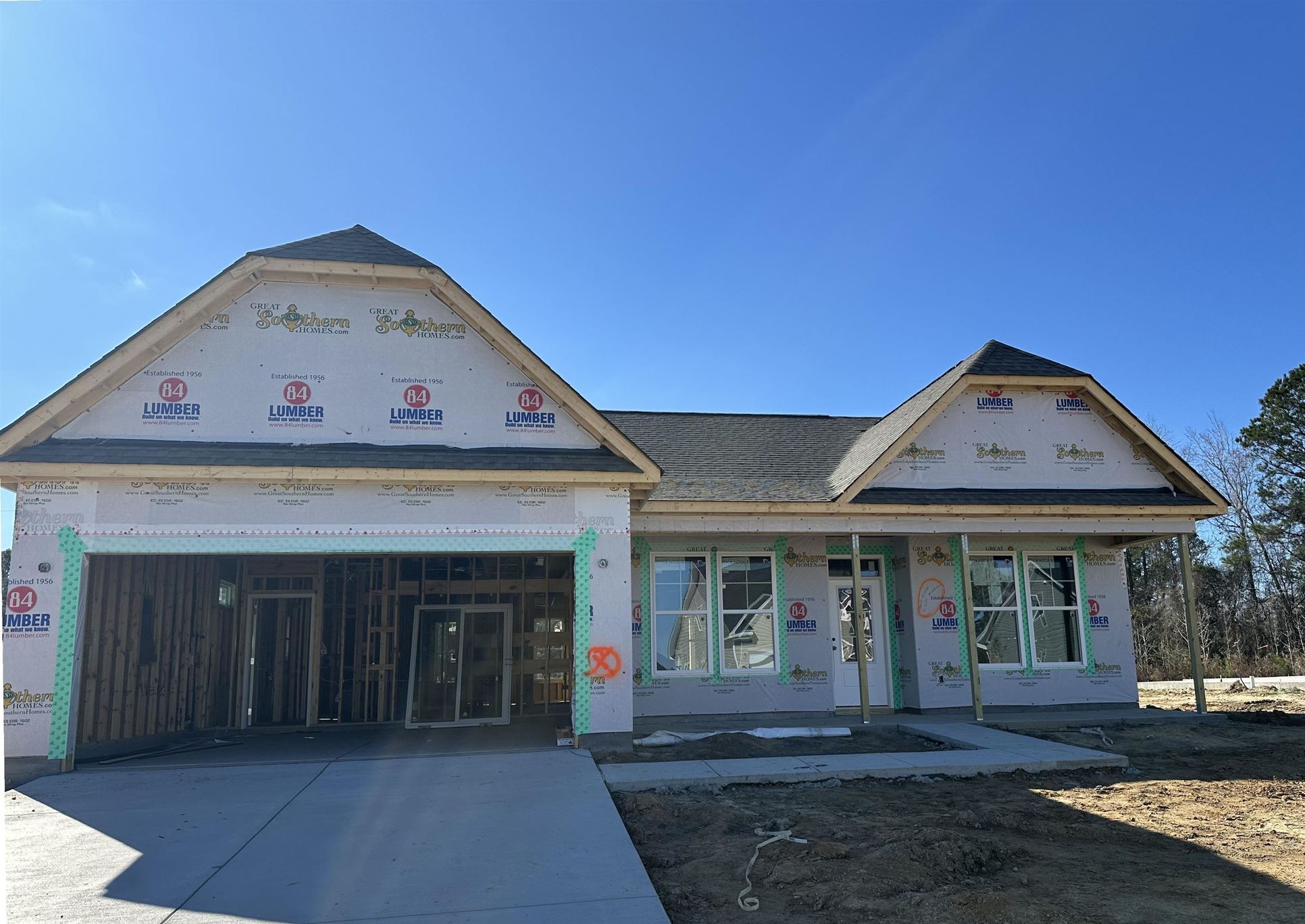 Exterior:Unfinished property with driveway and an attached garage