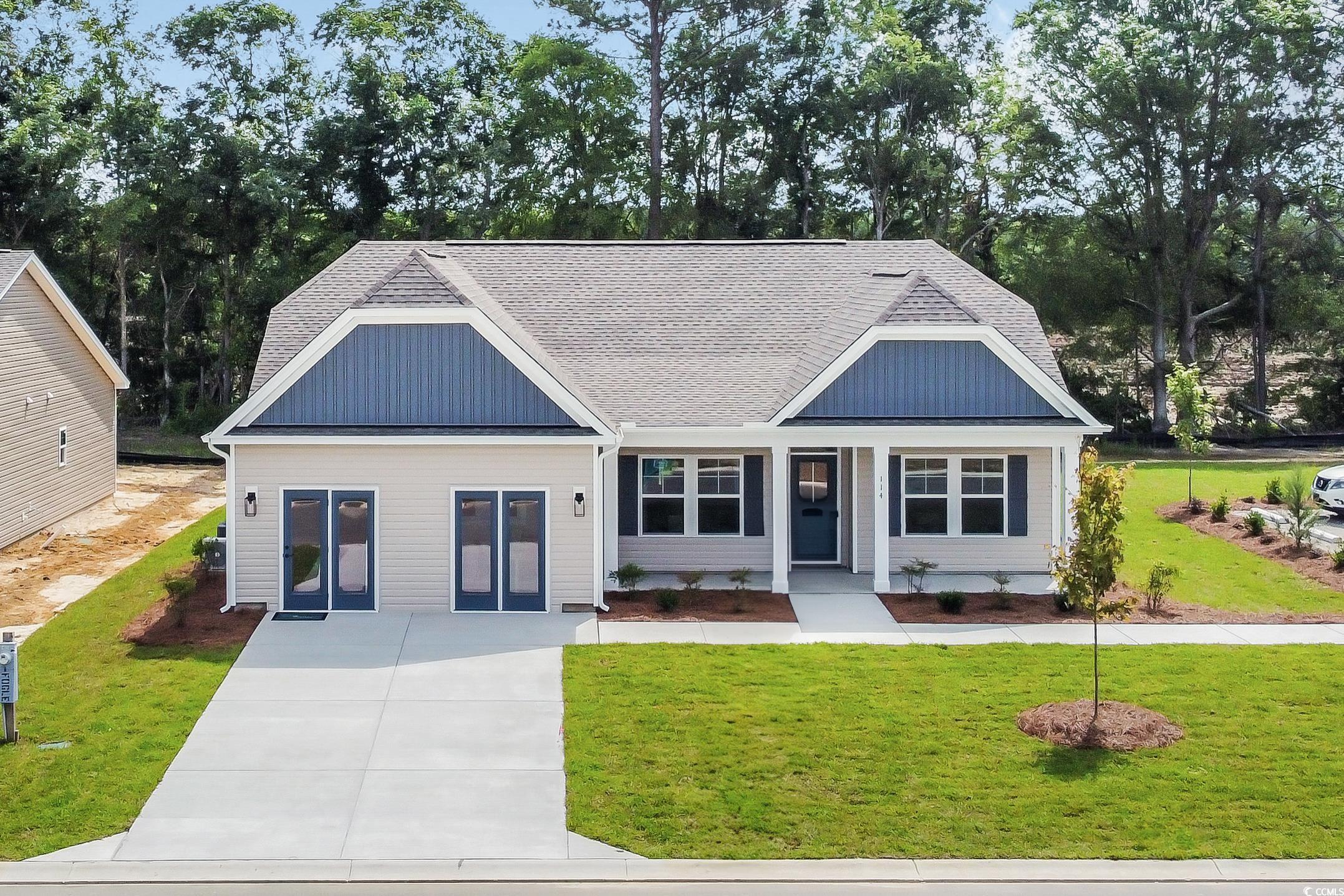 Exterior:View of front of house featuring a front yard, covered porch, roof with shingles, and view of scatt