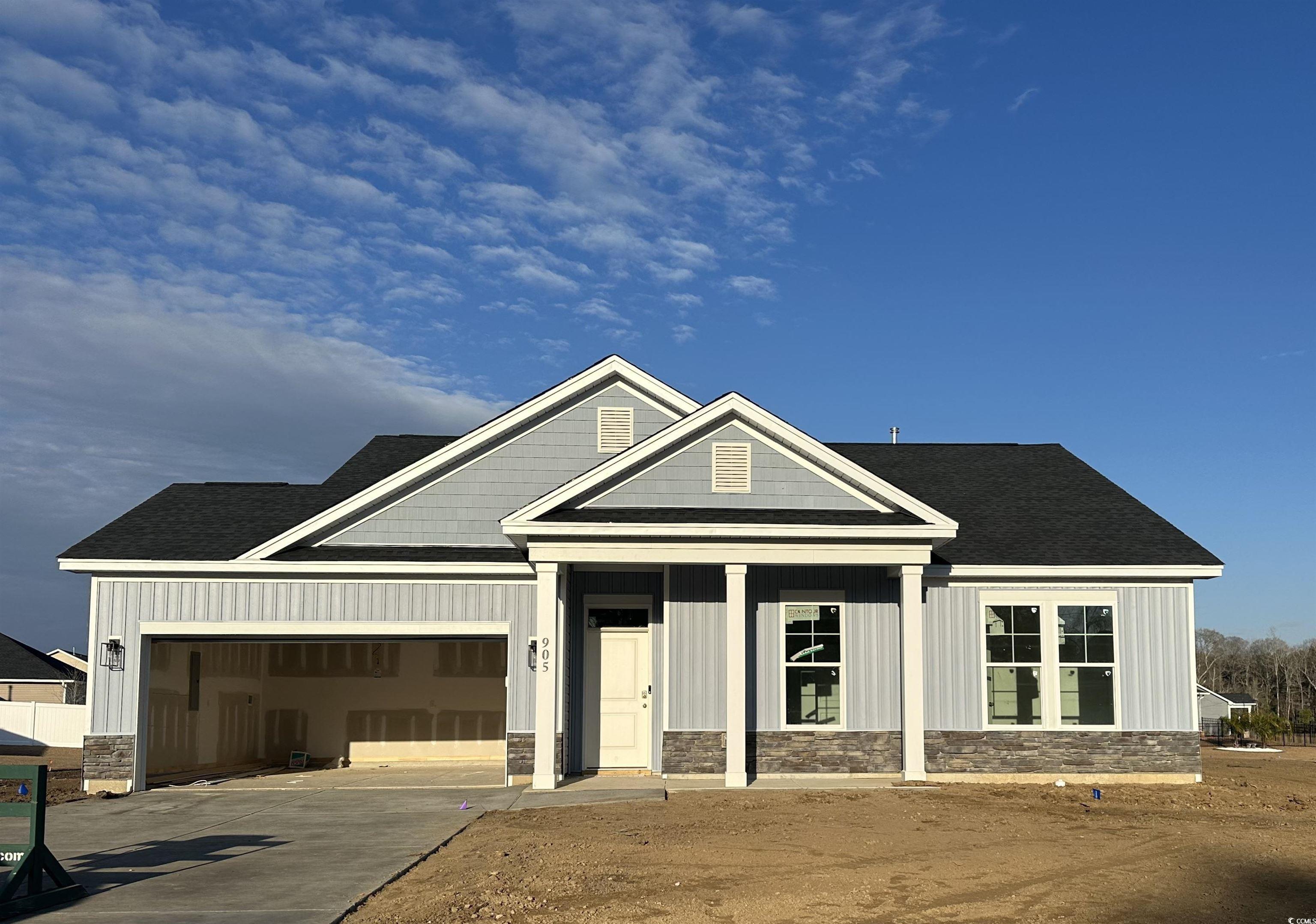 Exterior:View of front of home featuring roof with shingles, a porch, a garage, and board and batten siding