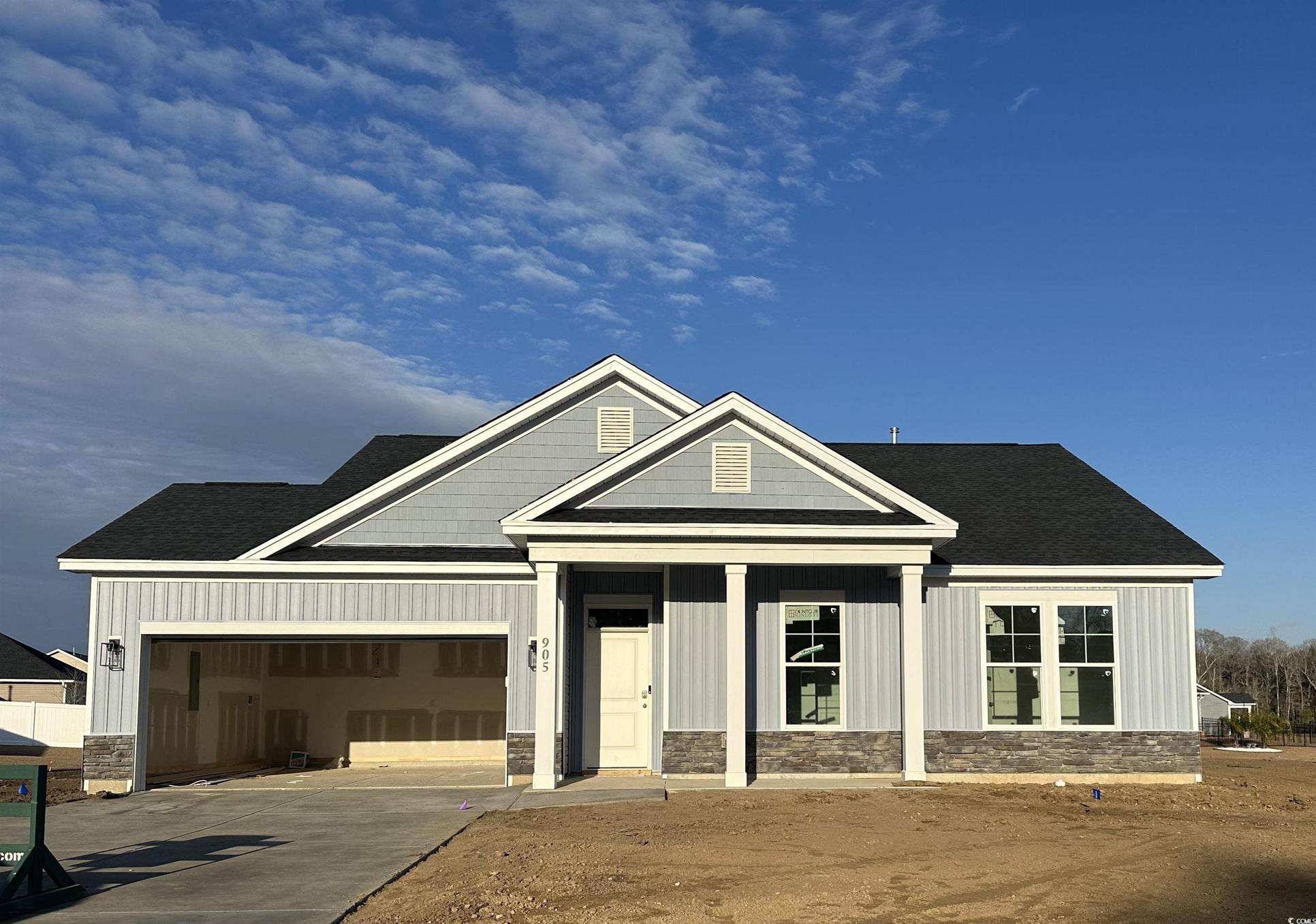 Exterior:View of front of home featuring roof with shingles, a porch, a garage, and board and batten siding