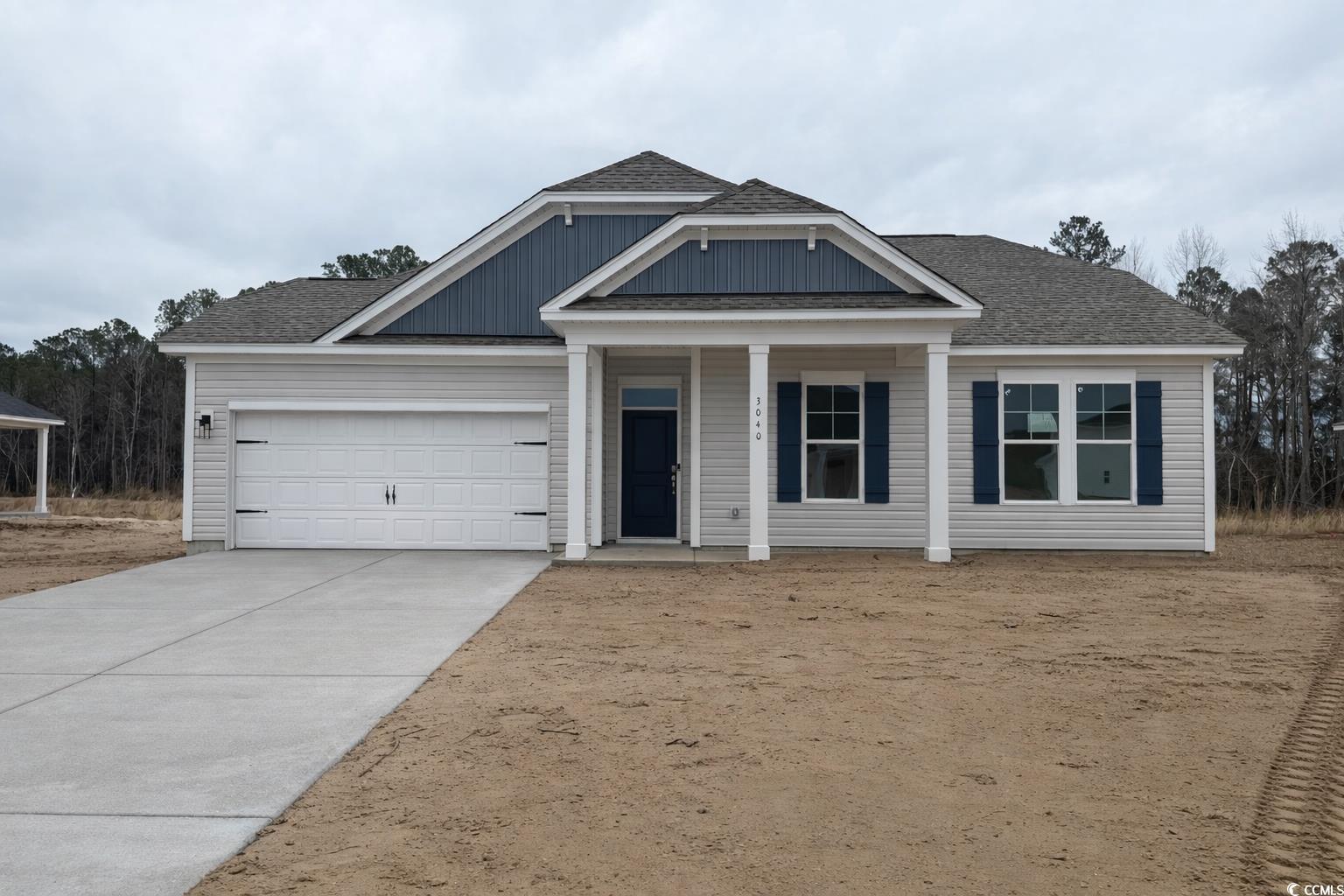 Exterior:Craftsman-style home featuring board and batten siding, a front yard, and concrete driveway