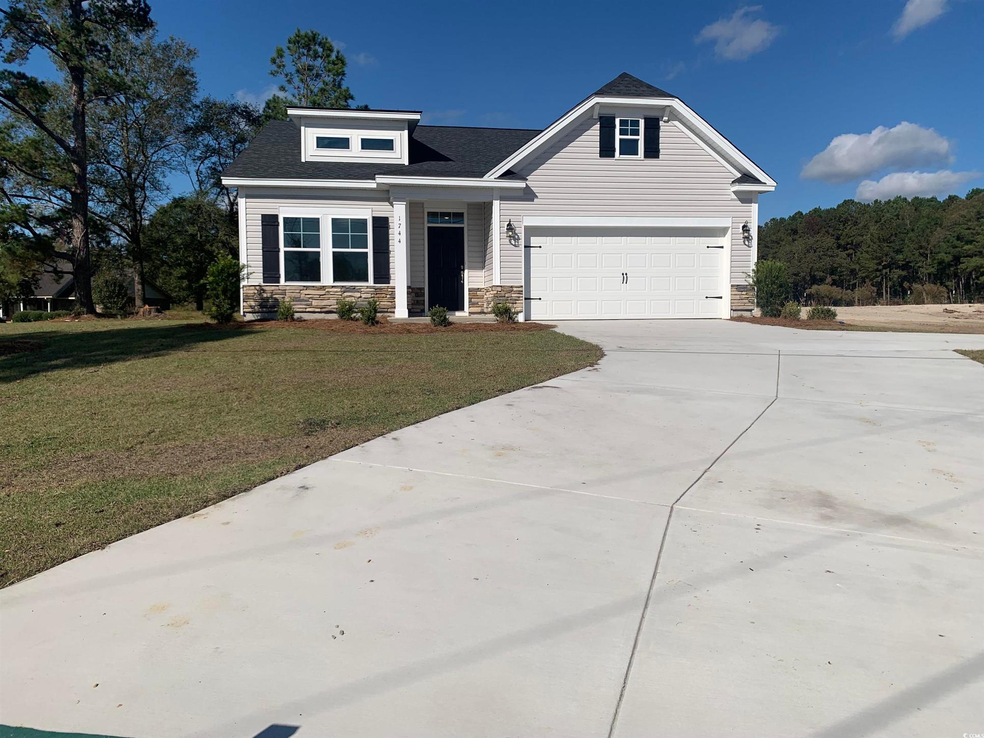Exterior:Craftsman-style house featuring a front lawn and a garage
