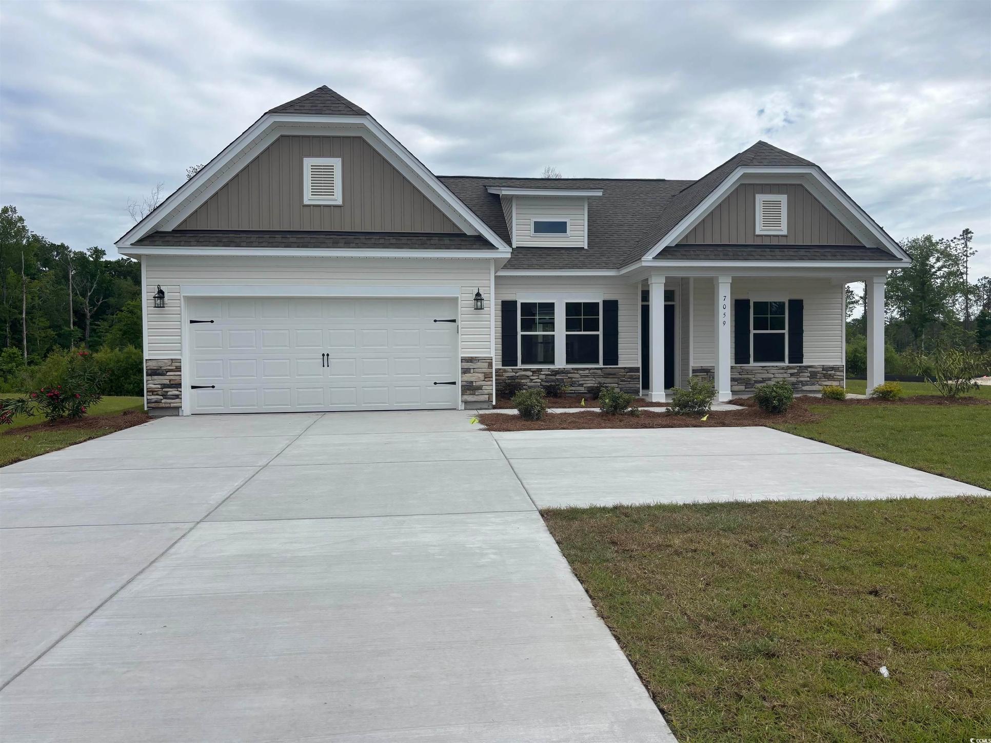 Exterior:Craftsman-style home with a front lawn, roof with shingles, and stone siding