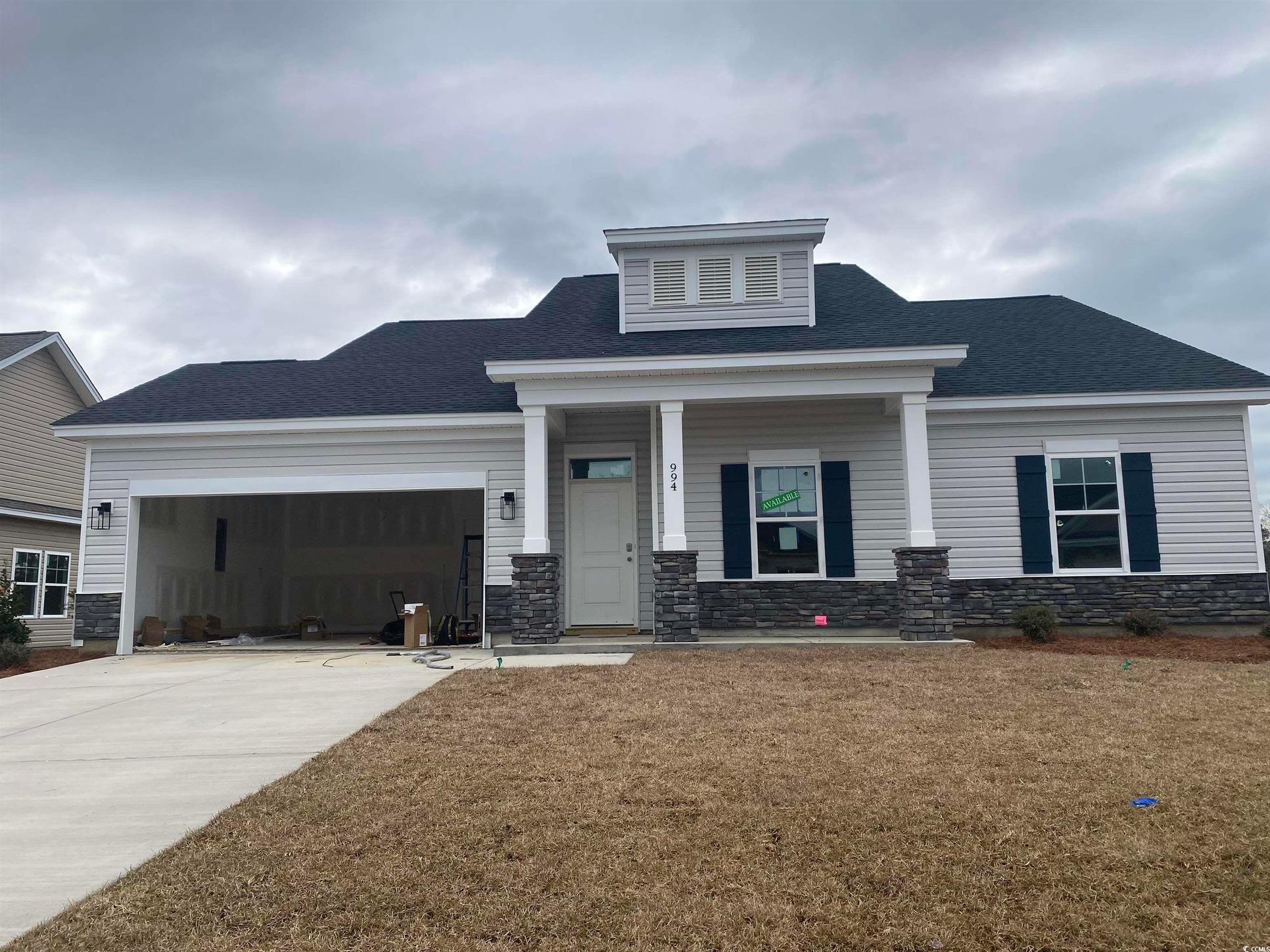Exterior:Craftsman-style home with stone siding, driveway, an attached garage, and a shingled roof