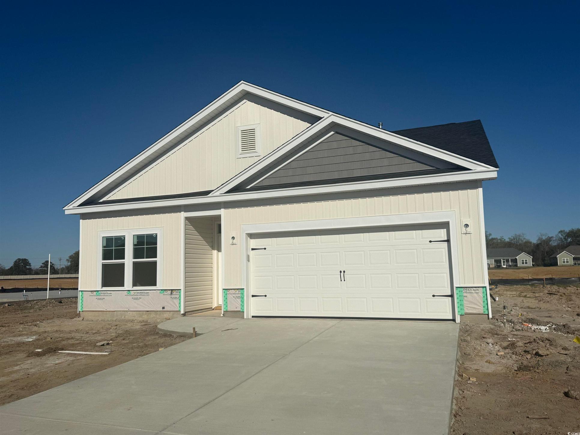 Exterior:View of front of home featuring a garage and concrete driveway