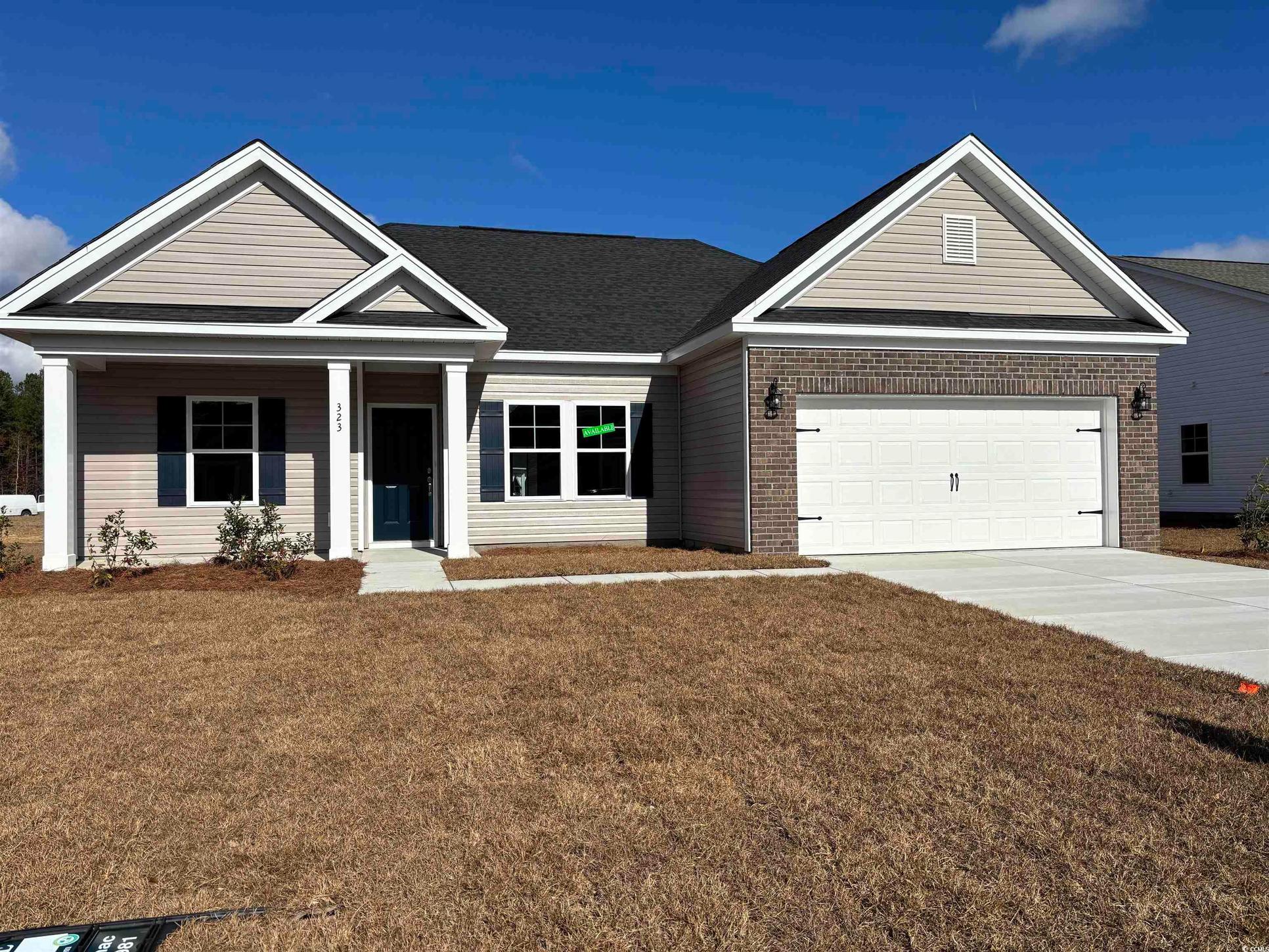 Exterior:View of front of home with a garage and a front lawn