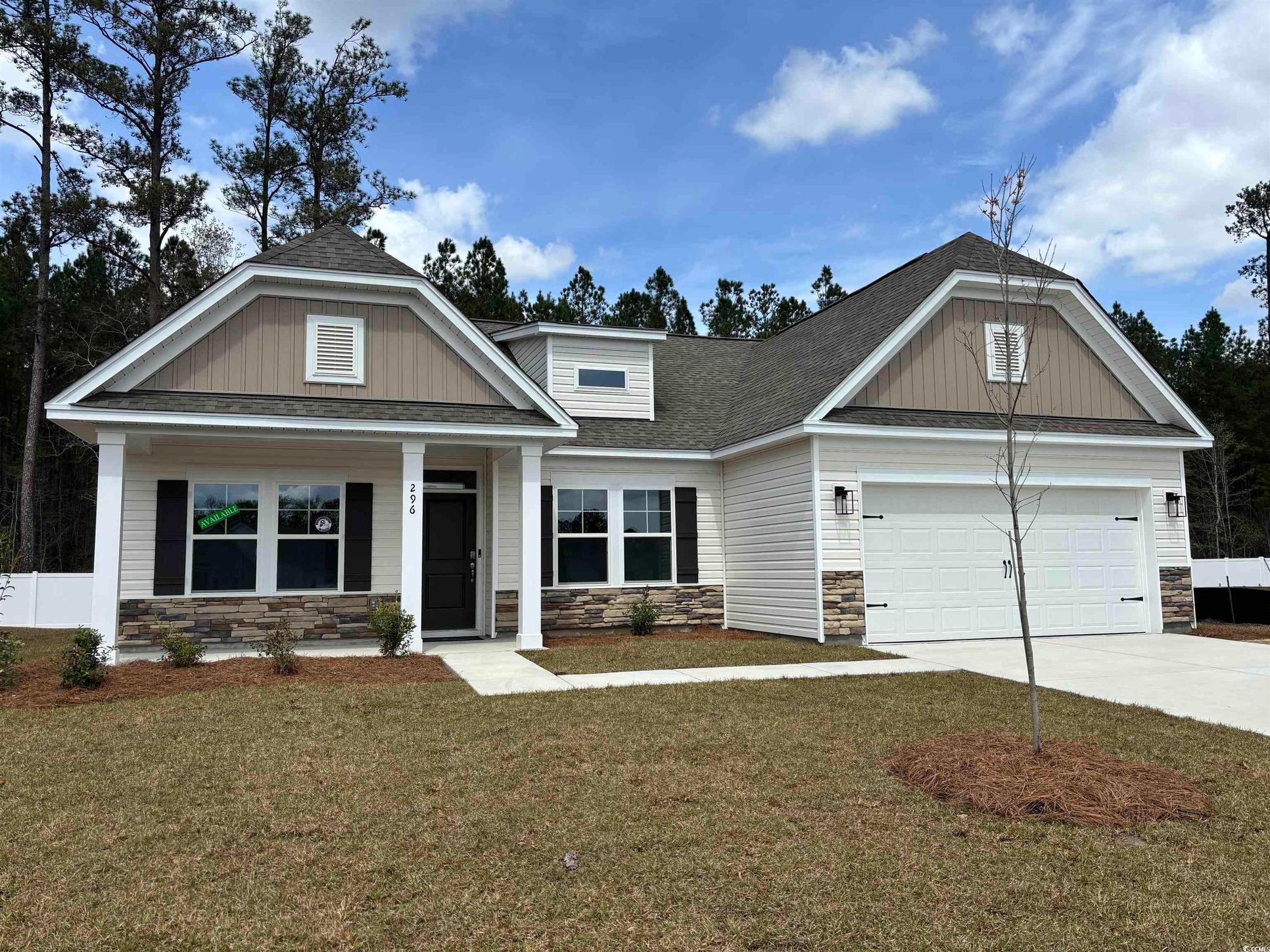 Exterior:Craftsman inspired home featuring stone siding, driveway, a garage, and roof with shingles