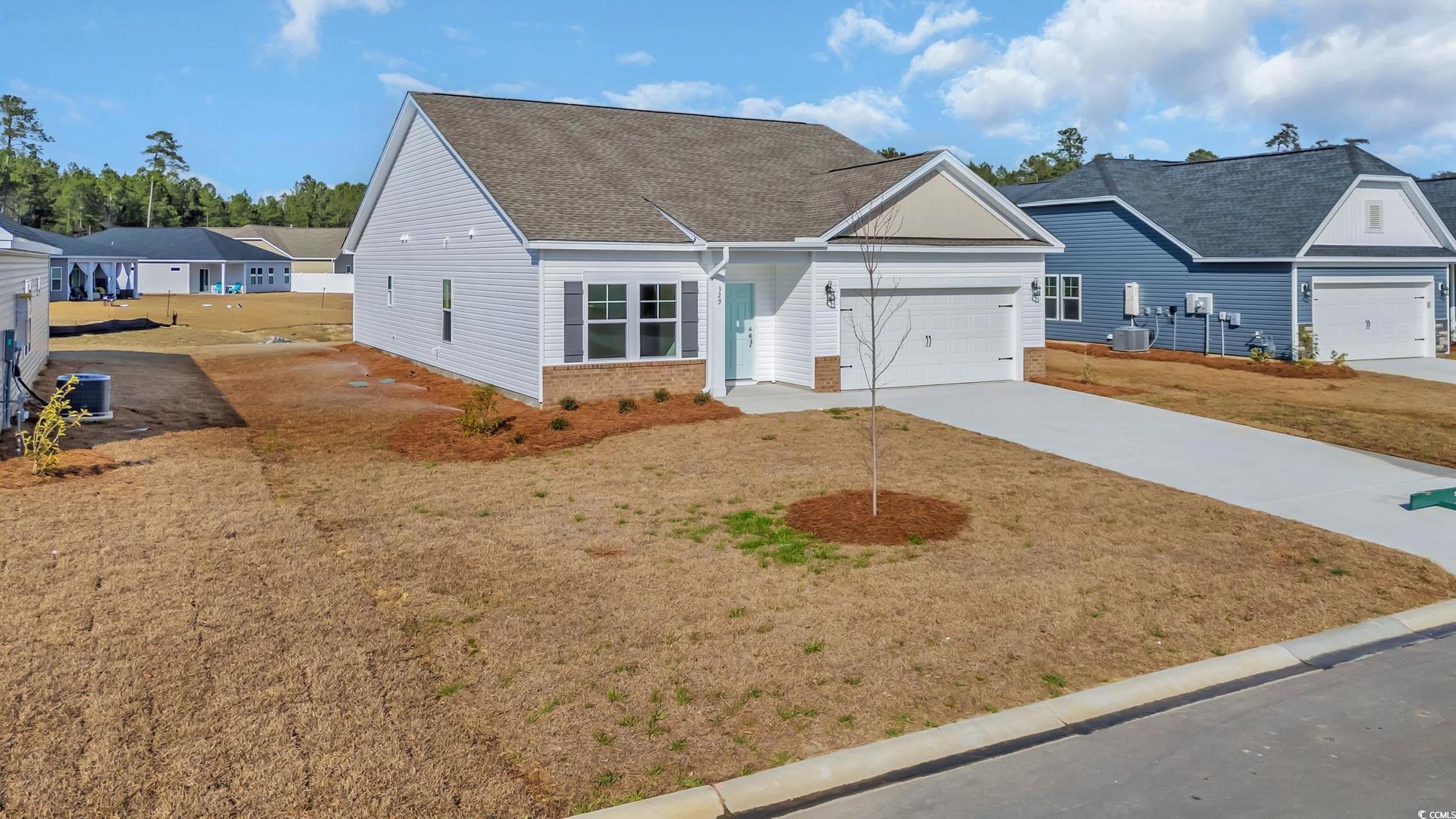 Exterior:View of front of house featuring central air condition unit, a front lawn, and a garage
