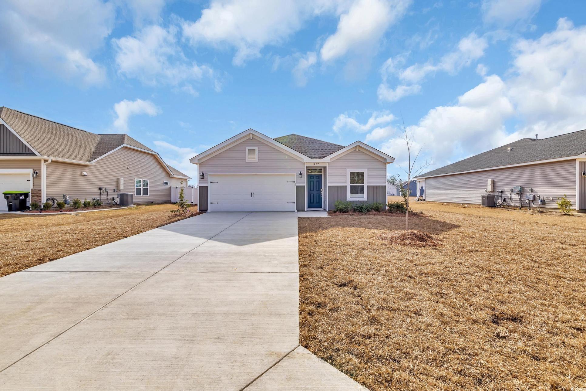 Exterior:Single story home featuring a front lawn, cooling unit, a garage, and driveway