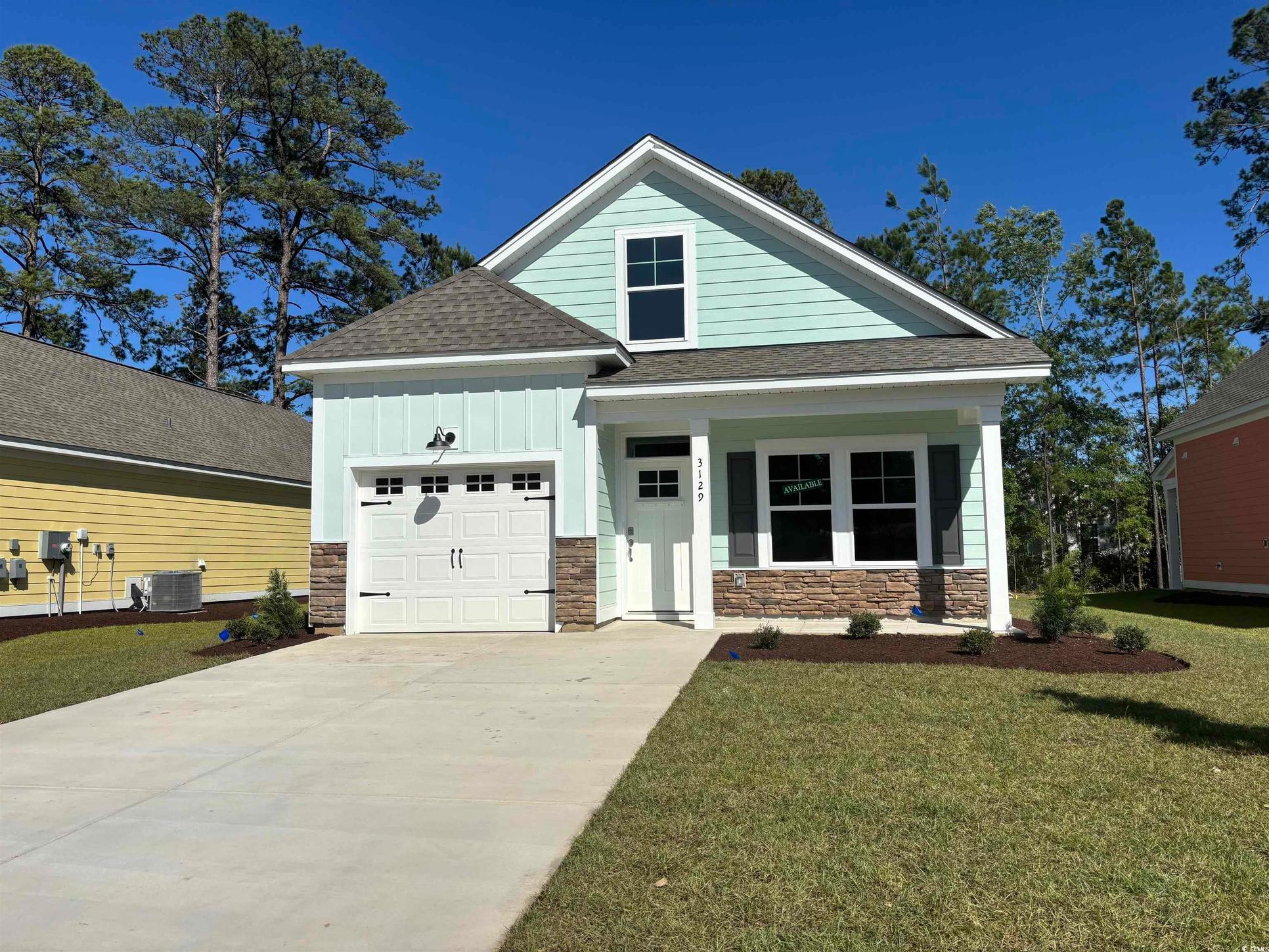 Exterior:Craftsman house featuring stone siding, an attached garage, a shingled roof, board and batten sidin