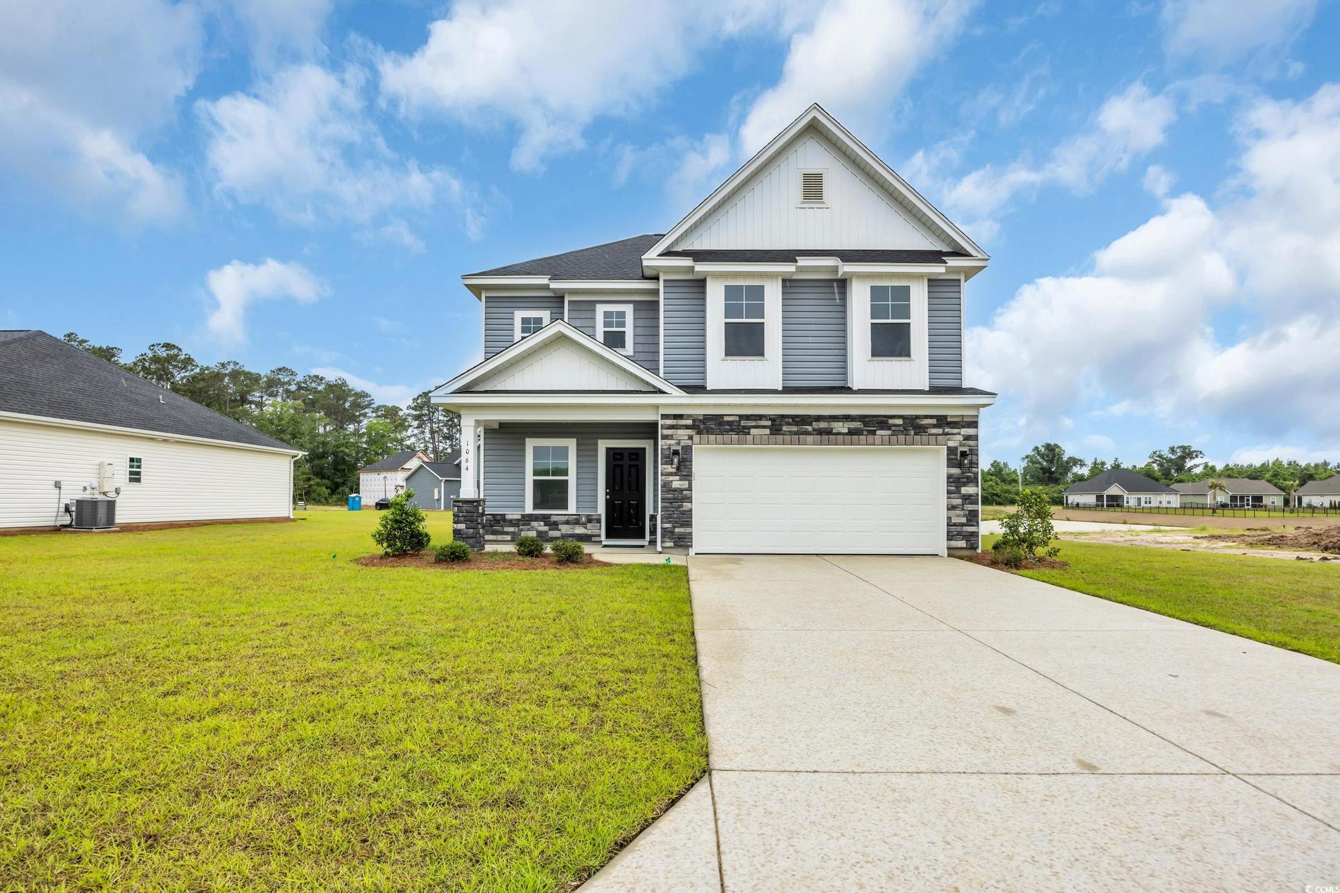 Exterior:Craftsman house with central air condition unit, stone siding, board and batten siding, a garage, a