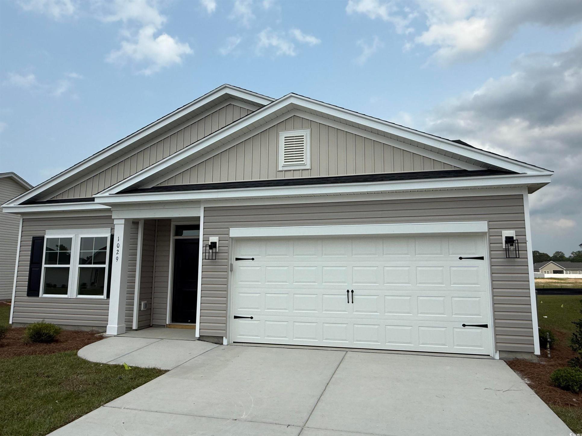 Exterior:Ranch-style house featuring concrete driveway and an attached garage
