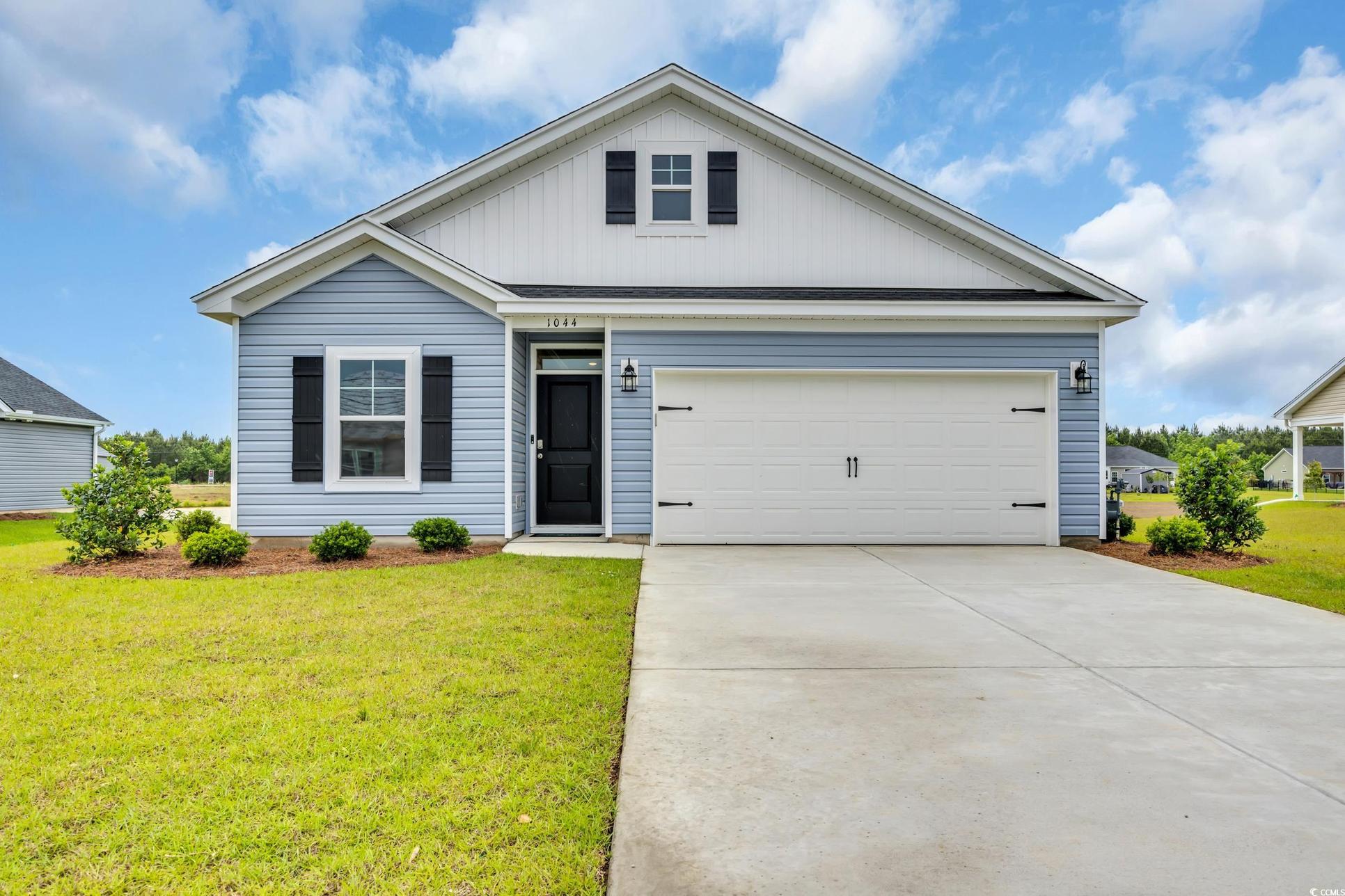 Exterior:View of front of home featuring a front lawn and driveway