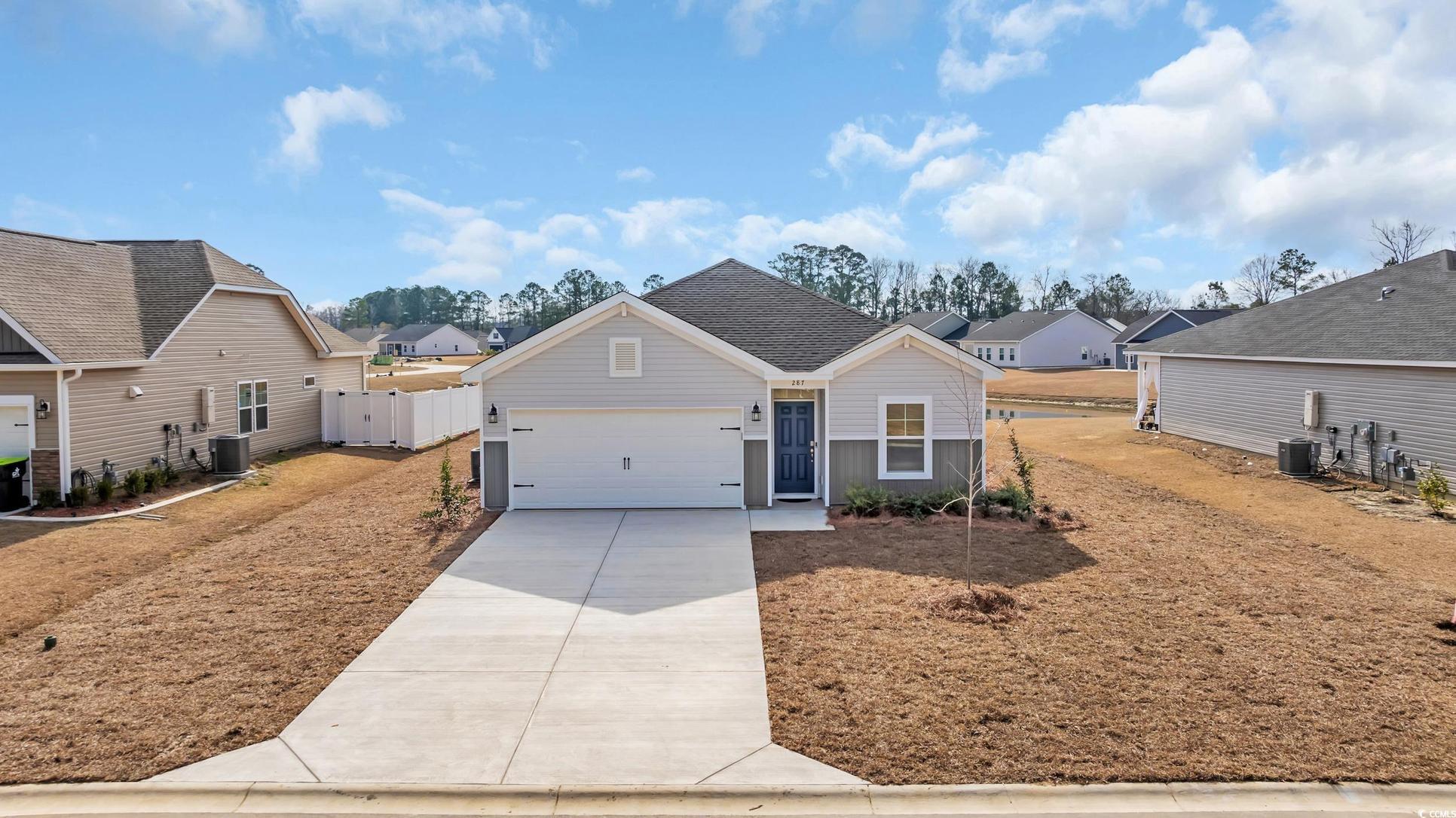 Exterior:View of front of house featuring driveway, fence, a residential view, roof with shingles, and a gar