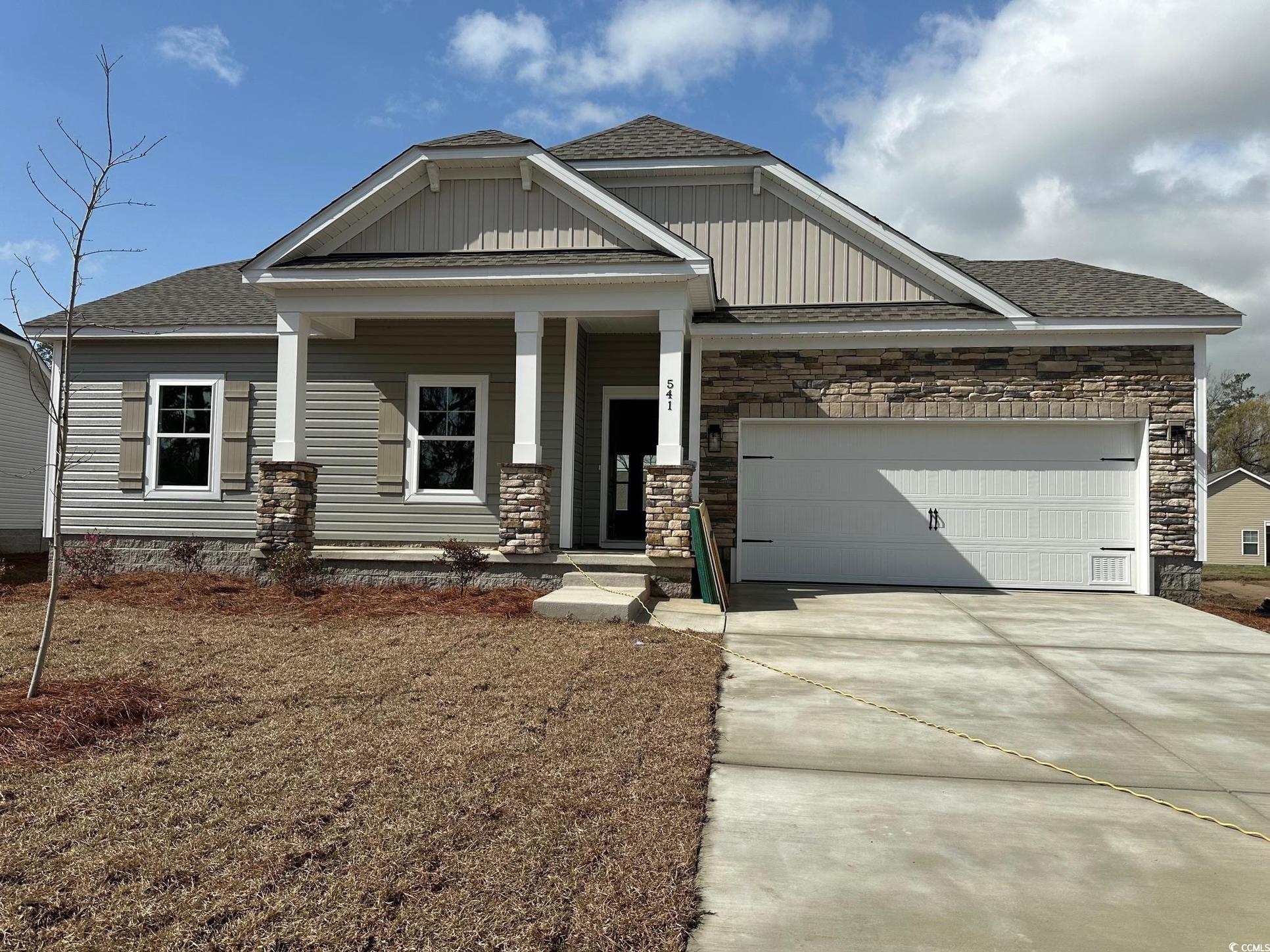 Exterior:Craftsman-style home featuring driveway, an attached garage, board and batten siding, and roof with