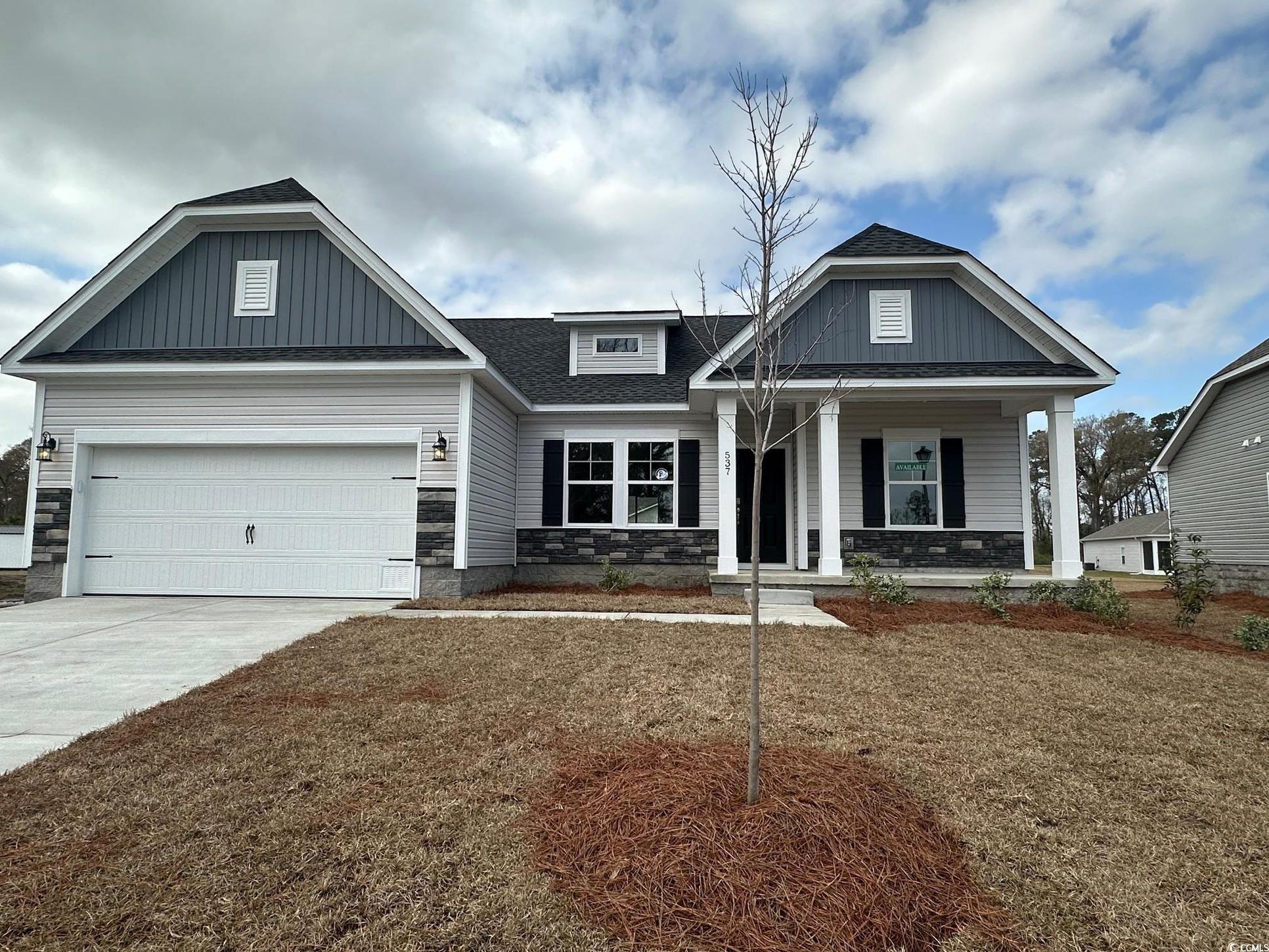 Exterior:Craftsman house with driveway, stone siding, board and batten siding, covered porch, and an attache