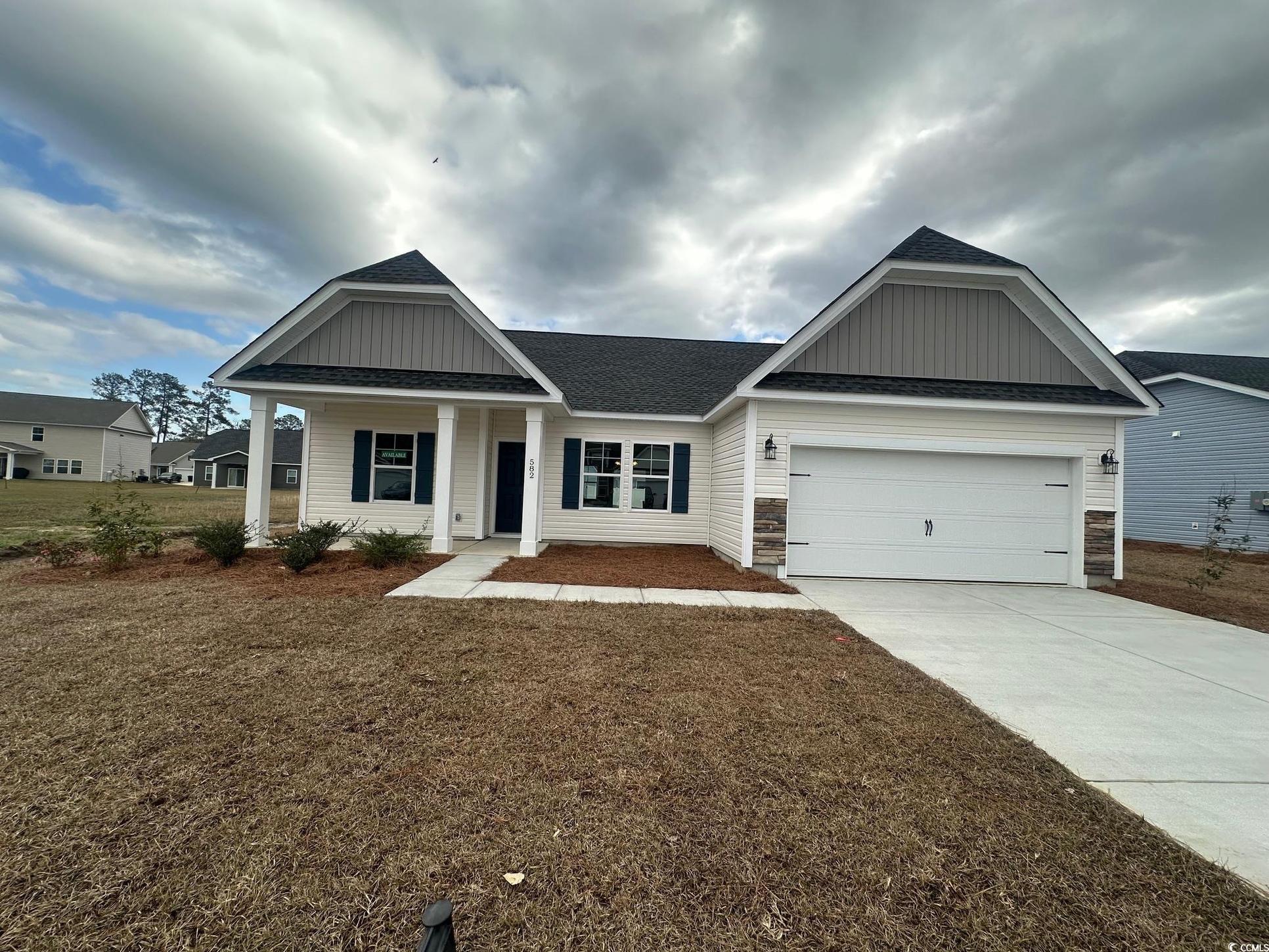 Exterior:View of front of home with a front lawn, driveway, a shingled roof, and an attached garage
