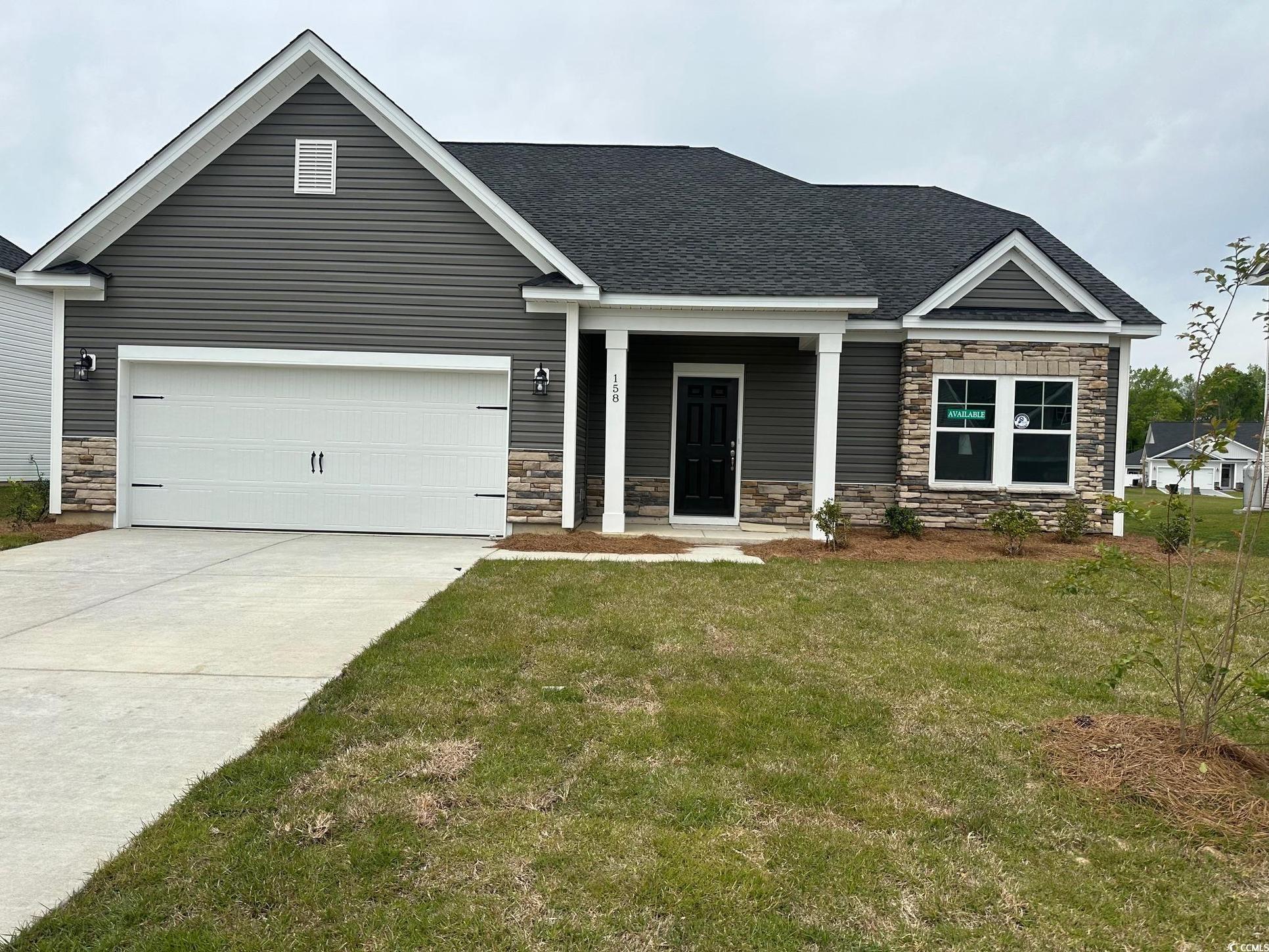 Exterior:Craftsman house with roof with shingles, a front yard, stone siding, an attached garage, and drivew