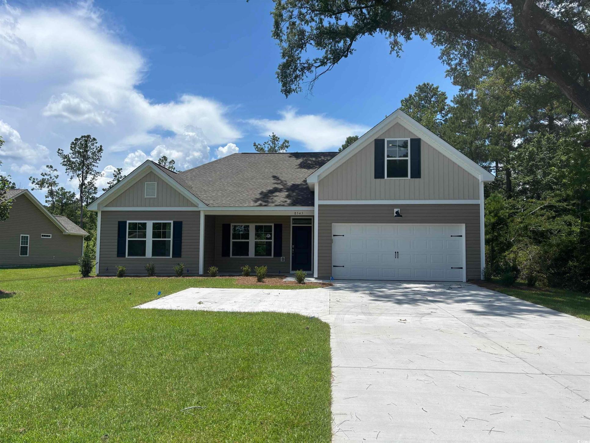 Exterior:View of front facade featuring a front lawn and driveway