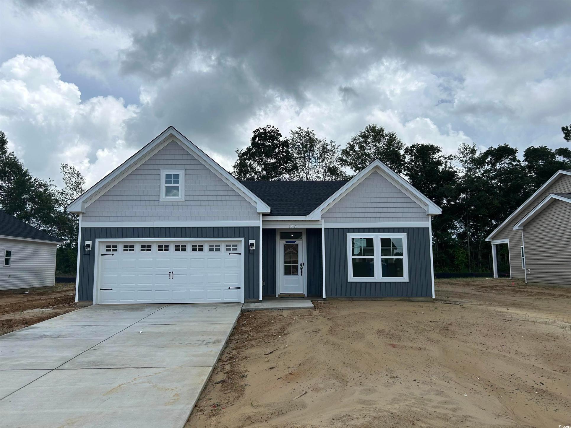 Exterior:View of front of home featuring board and batten siding and driveway