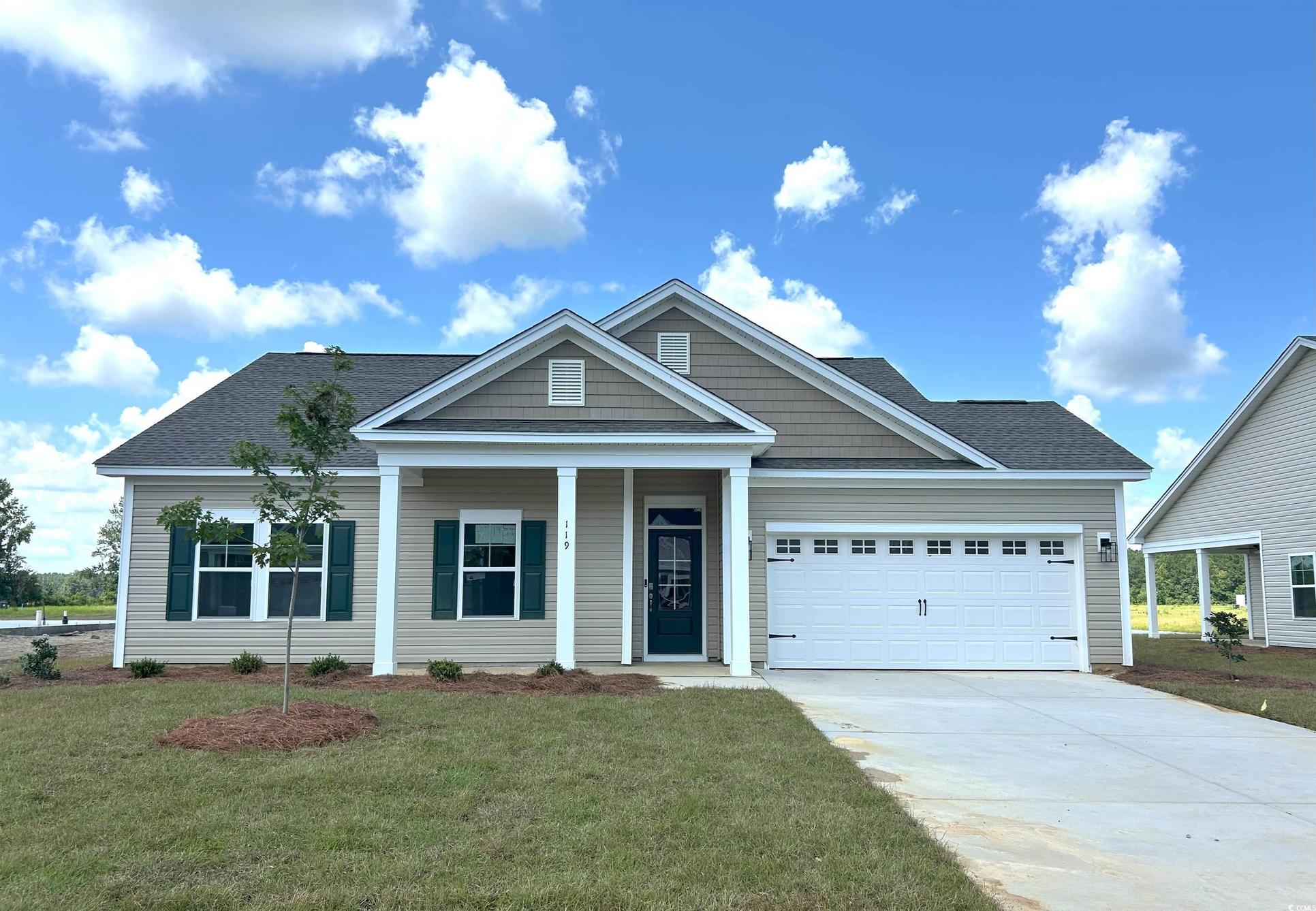 Exterior:View of front of home with an attached garage, concrete driveway, a front yard, and roof with shing
