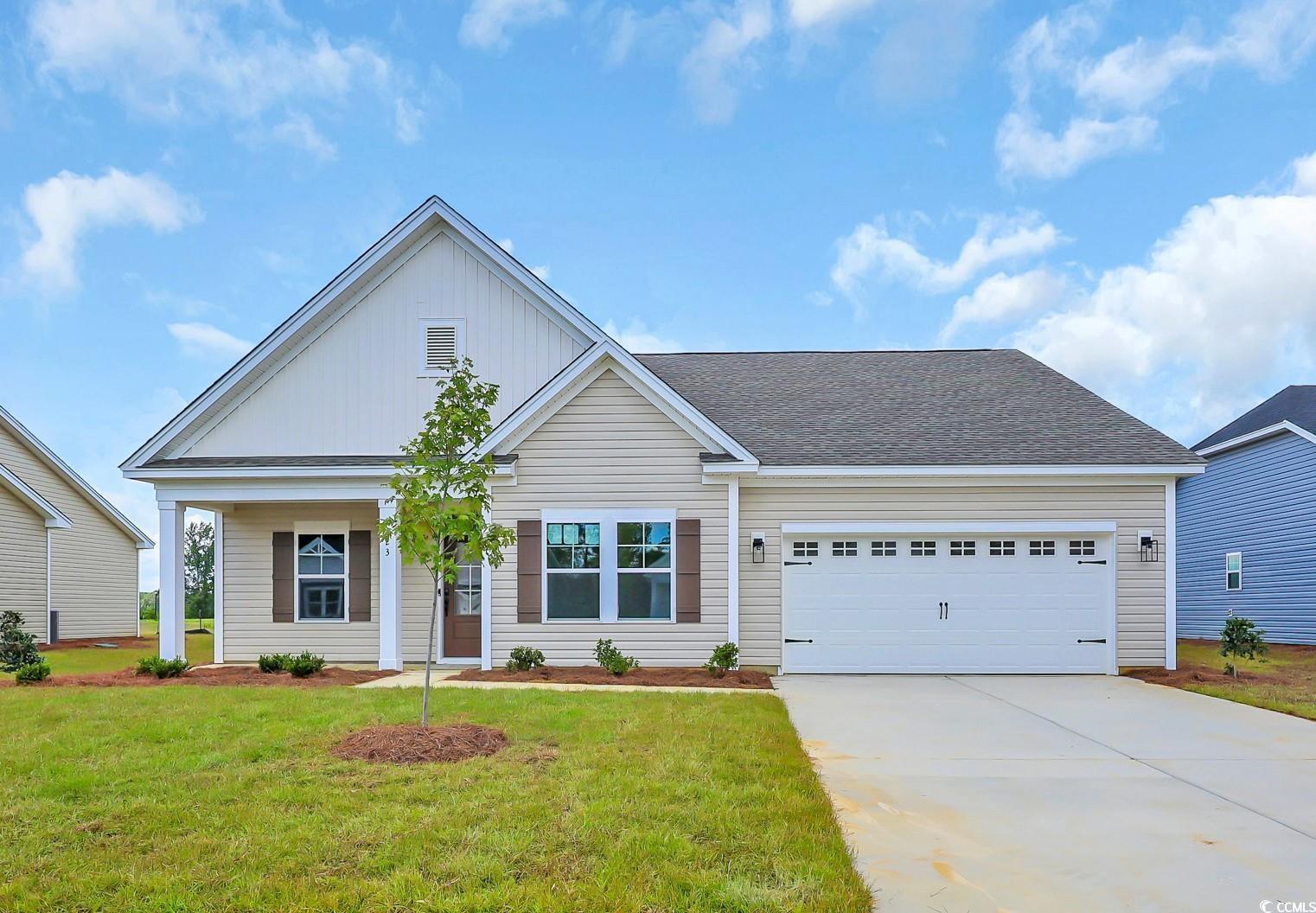 Exterior:View of front of home featuring concrete driveway, a front lawn, an attached garage, a shingled roo
