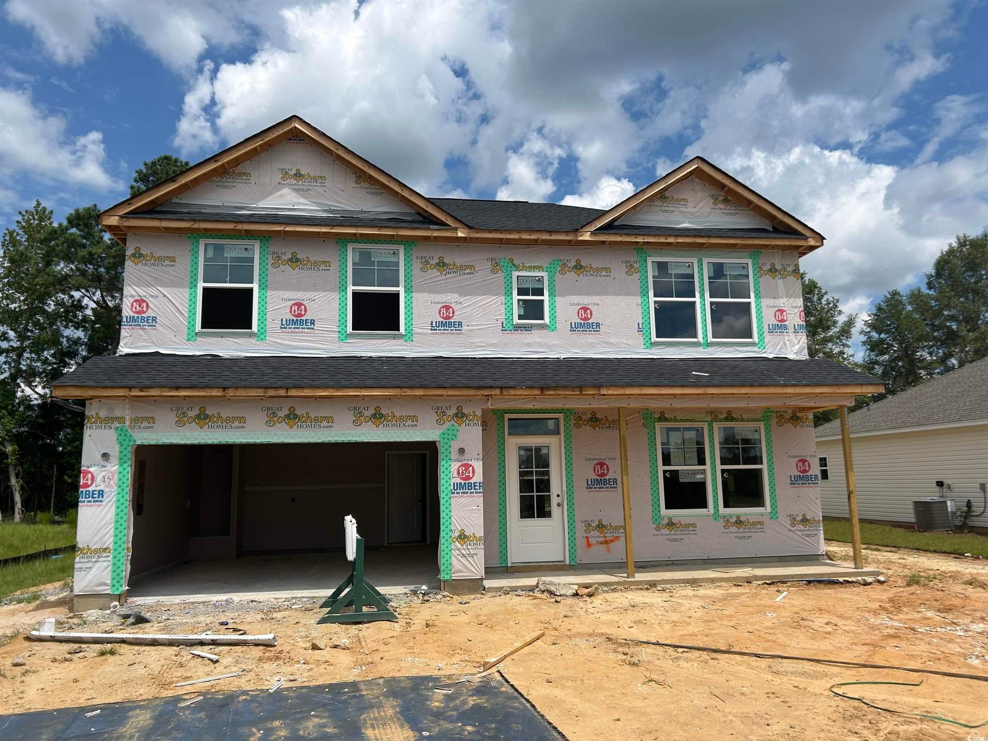 Exterior:Property under construction featuring an attached garage, a porch, and roof with shingles