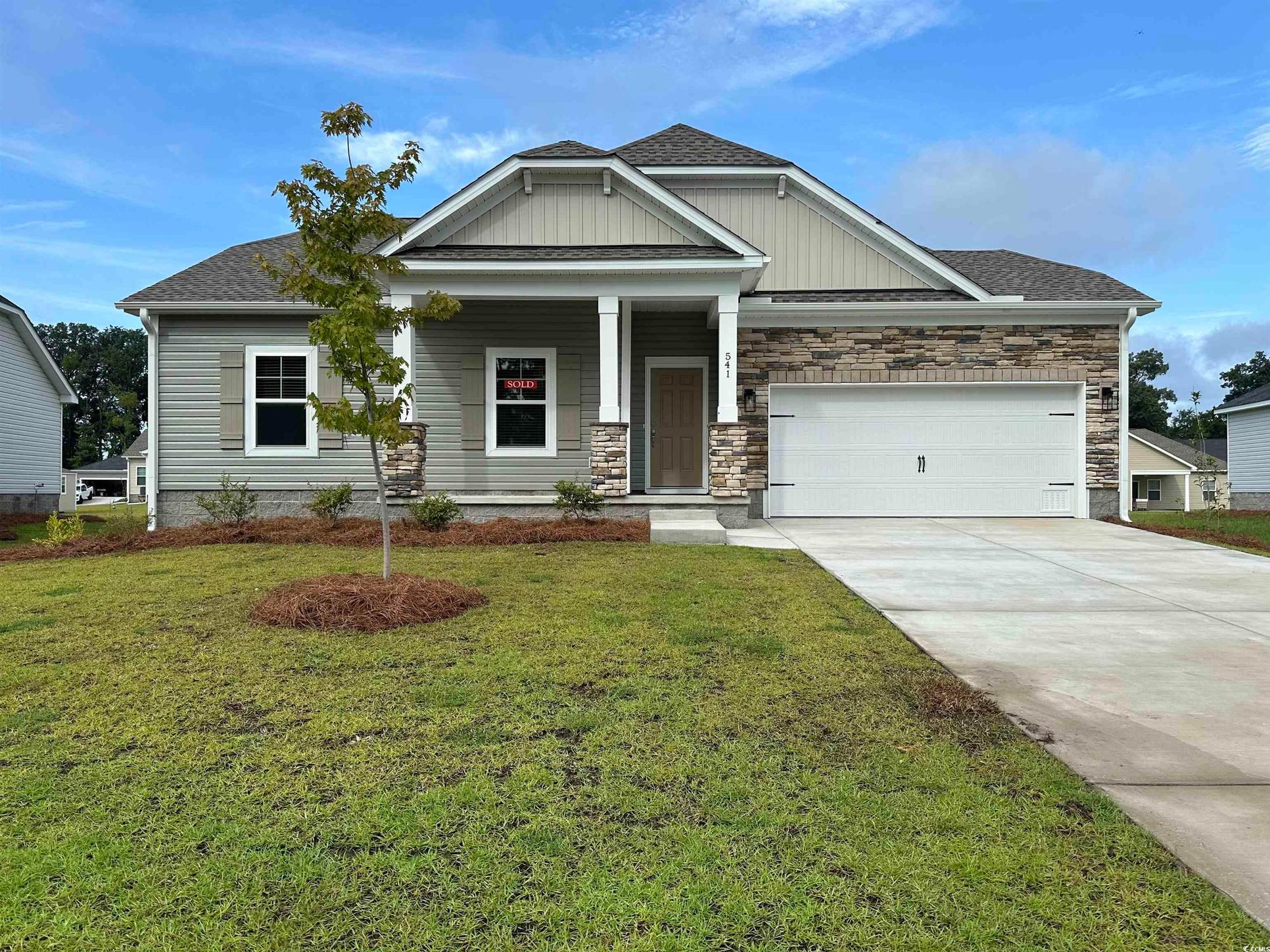 Exterior:Craftsman inspired home with an attached garage, driveway, a front lawn, and roof with shingles