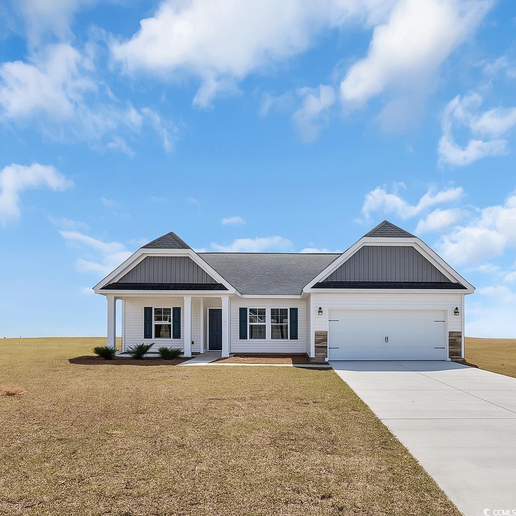 Exterior:View of front of house with a front lawn, driveway, a garage, and a shingled roof