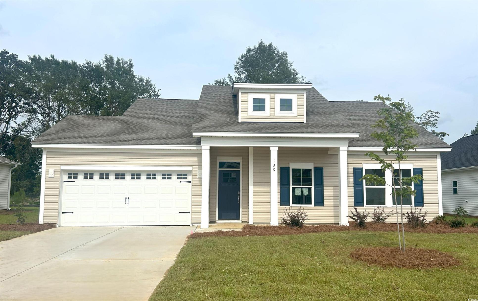 Exterior:View of front of home with roof with shingles, a front lawn, a garage, and driveway