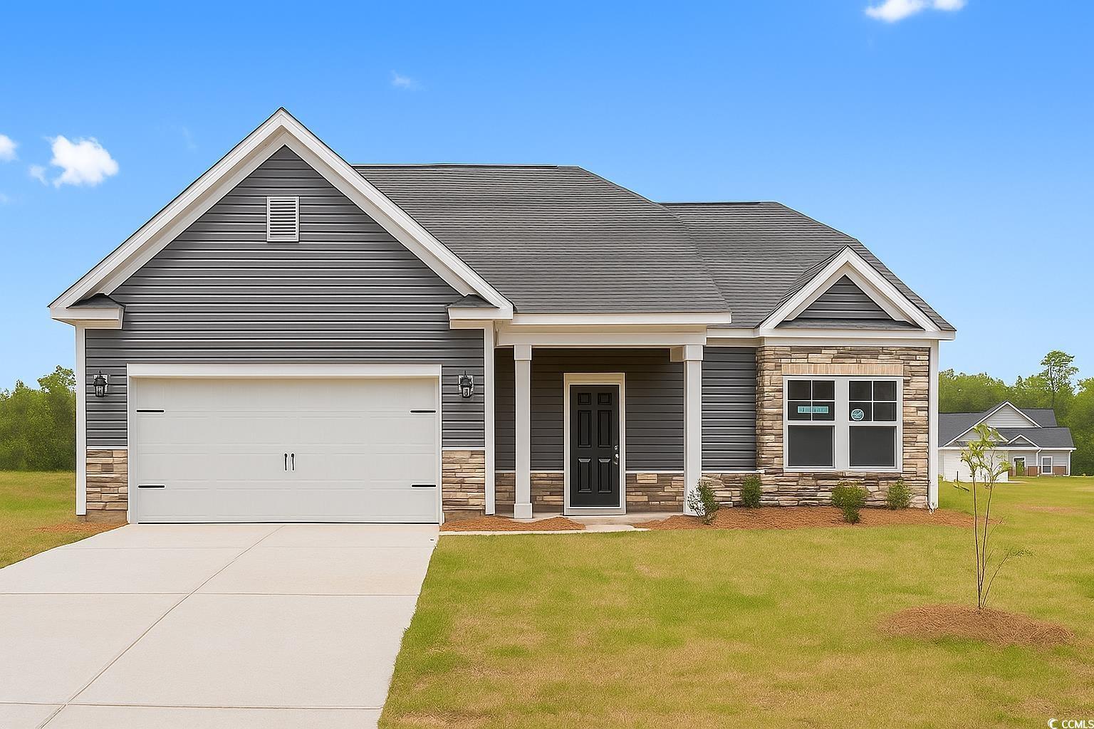 Exterior:View of front of home with stone siding, concrete driveway, a front lawn, and an attached garage