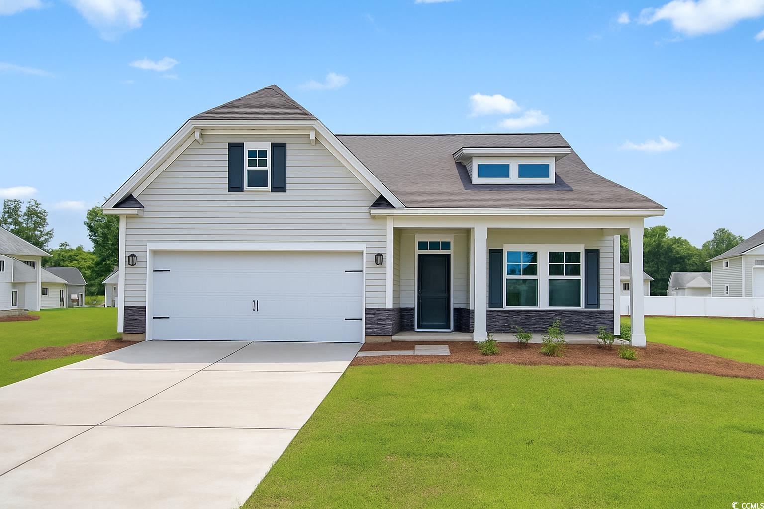 Exterior:View of front of house featuring stone siding, a front yard, concrete driveway, and roof with shing