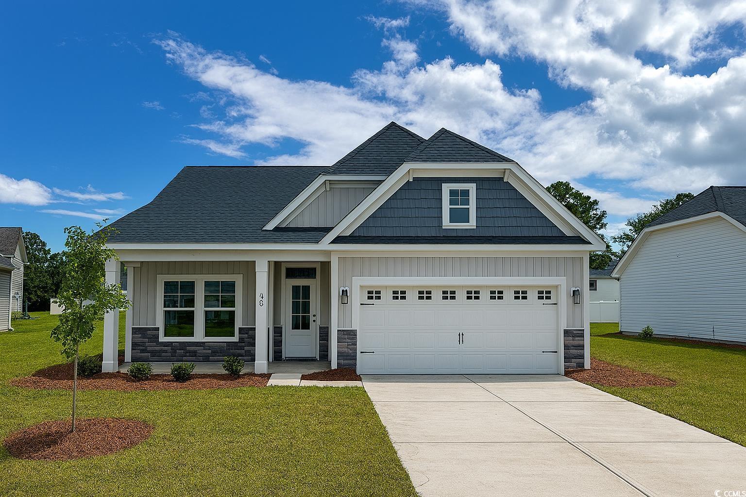 Exterior:Craftsman inspired home with a front lawn, stone siding, and a shingled roof