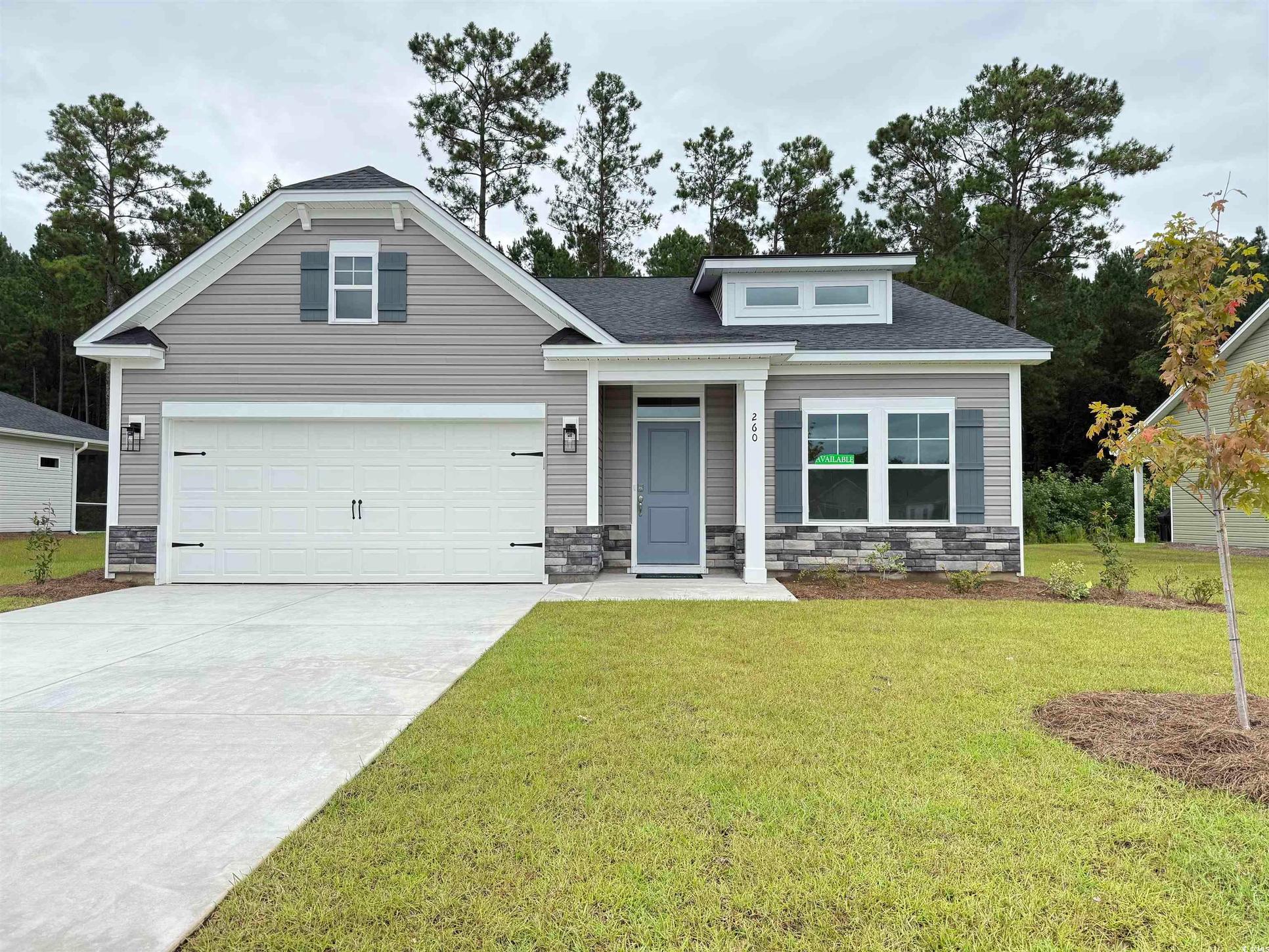 Exterior:Craftsman inspired home featuring concrete driveway, stone siding, an attached garage, and a shingl