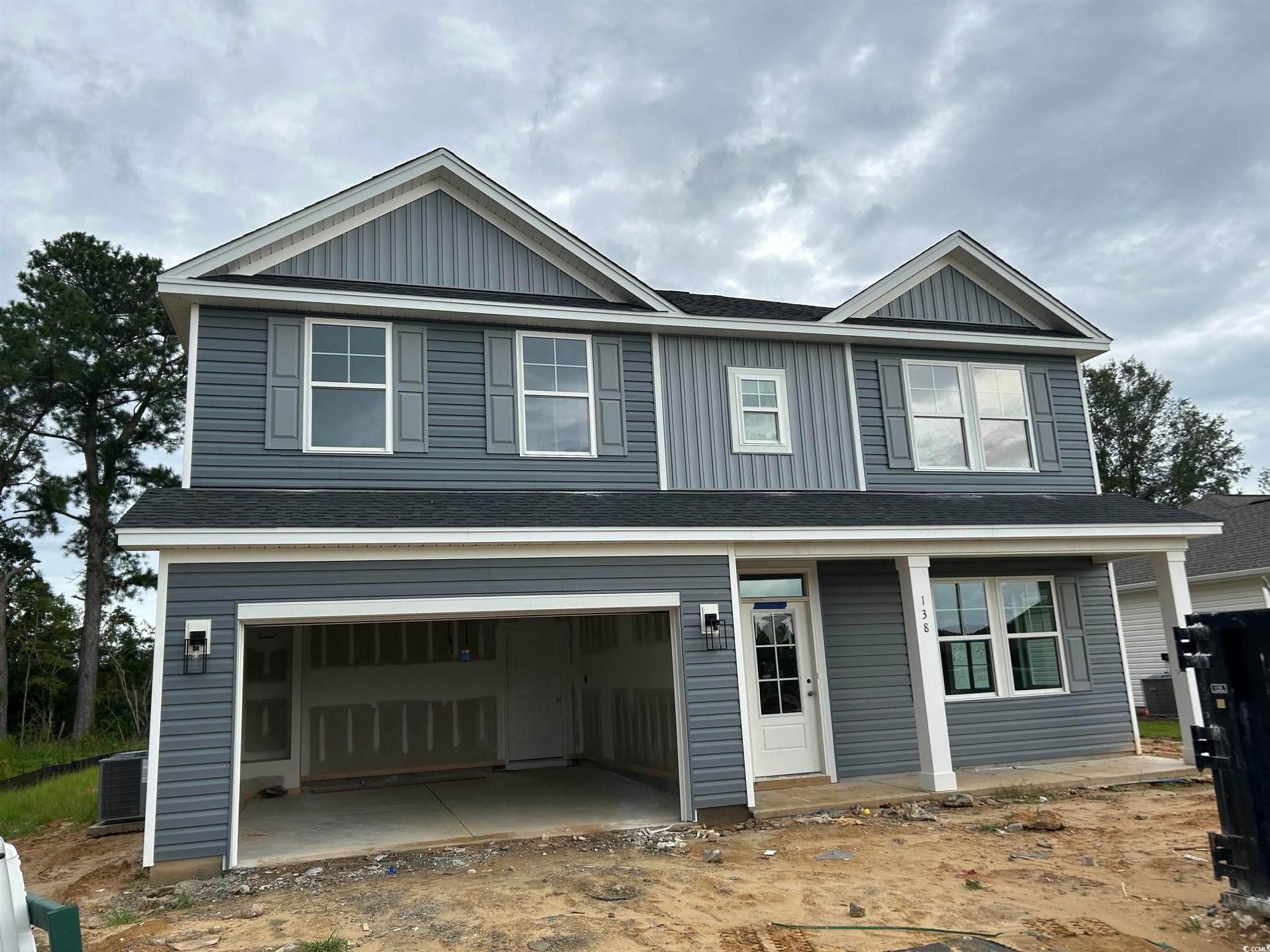 Exterior:View of front of property featuring a shingled roof, board and batten siding, covered porch, and an