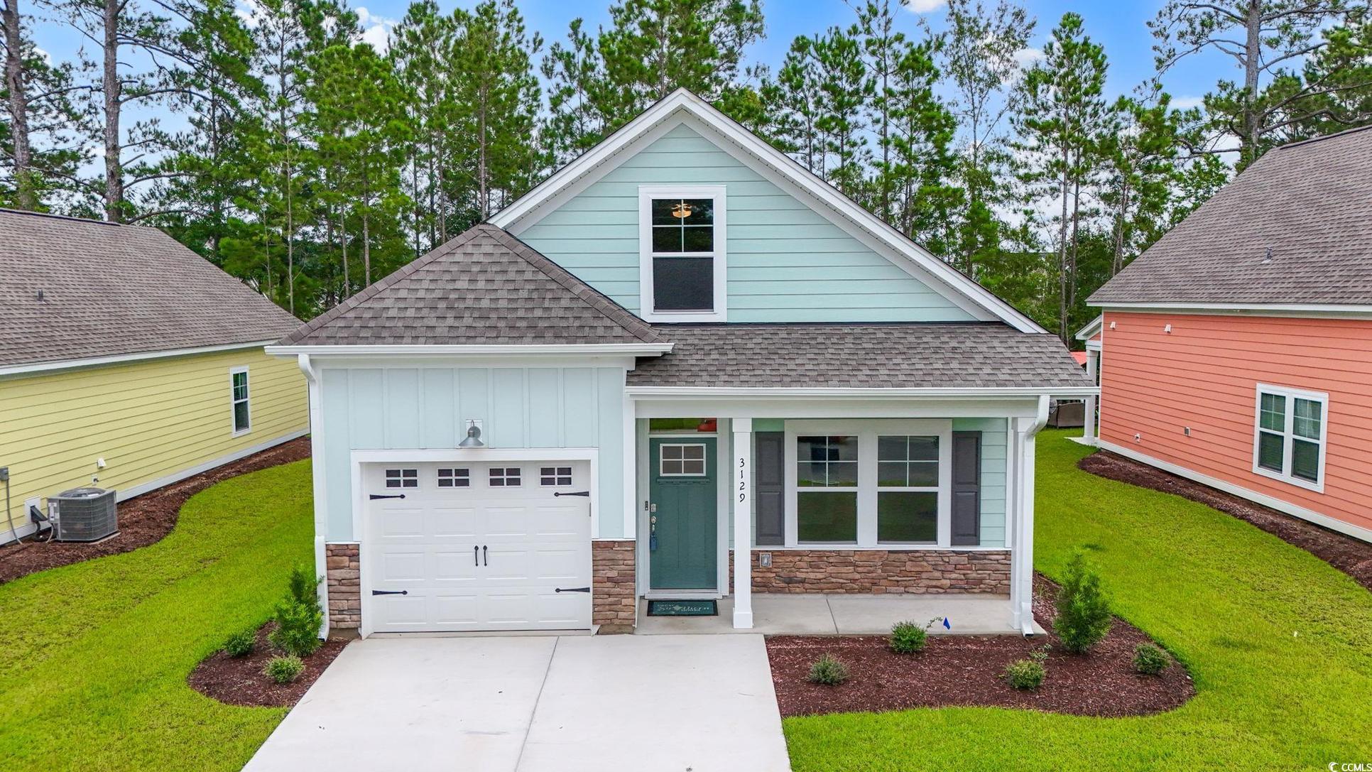 Exterior:Craftsman house with a shingled roof, driveway, stone siding, an attached garage, and board and bat
