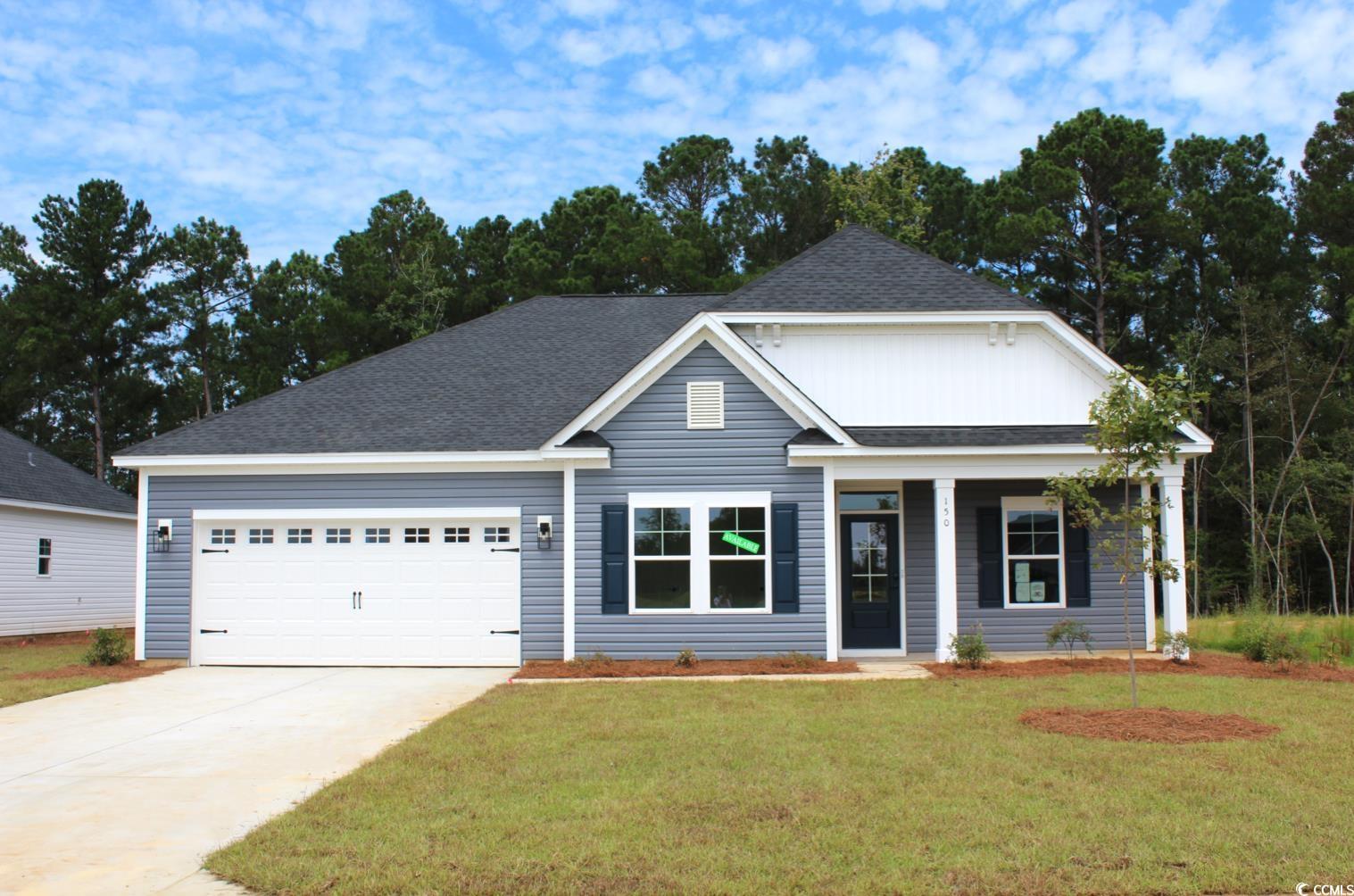 Exterior:View of front of house featuring roof with shingles, an attached garage, covered porch, concrete dr