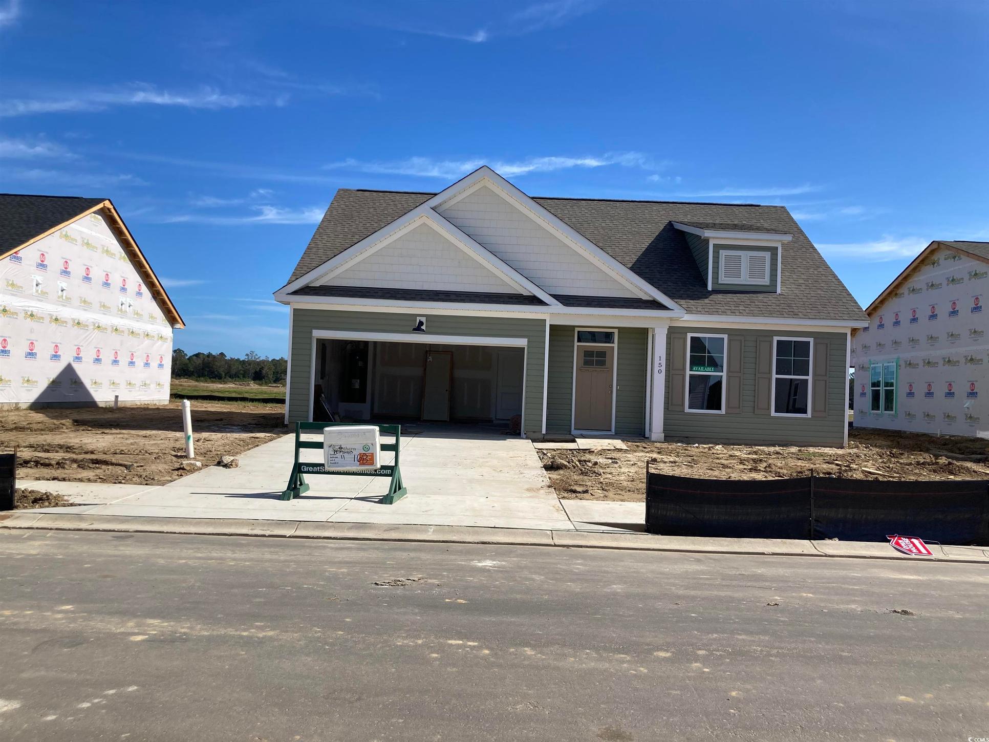 Exterior:View of front of property with concrete driveway, an attached garage, and roof with shingles