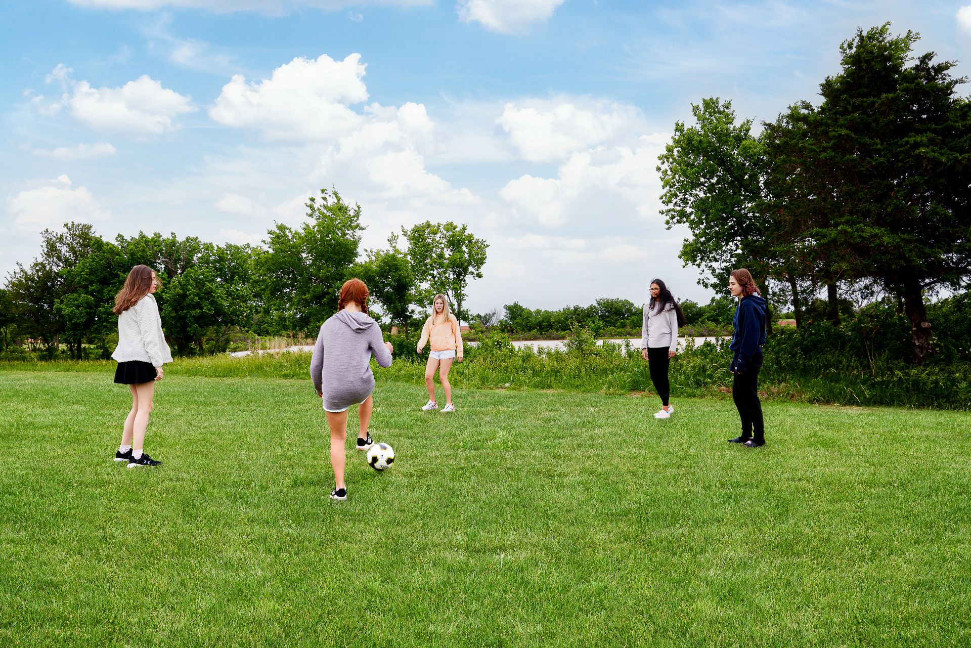 Soccer in green space at new community in Moore, OK:Green Space & Pond