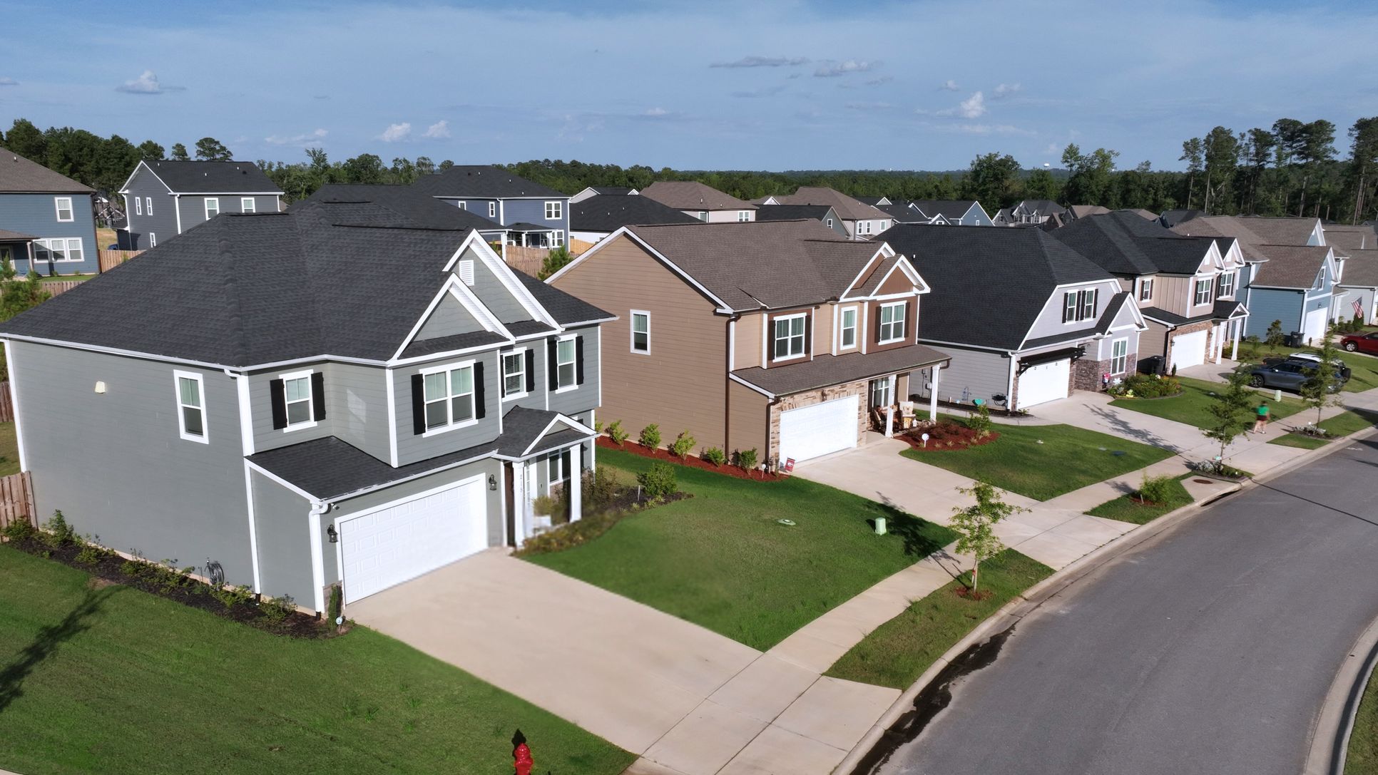 Street-level photo of Ivey Homes in Tillery Park, Grovetown GA with driveways, garages, and lands...:Tillery Park | New Homes by Ivey Homes in Grovetown, GA