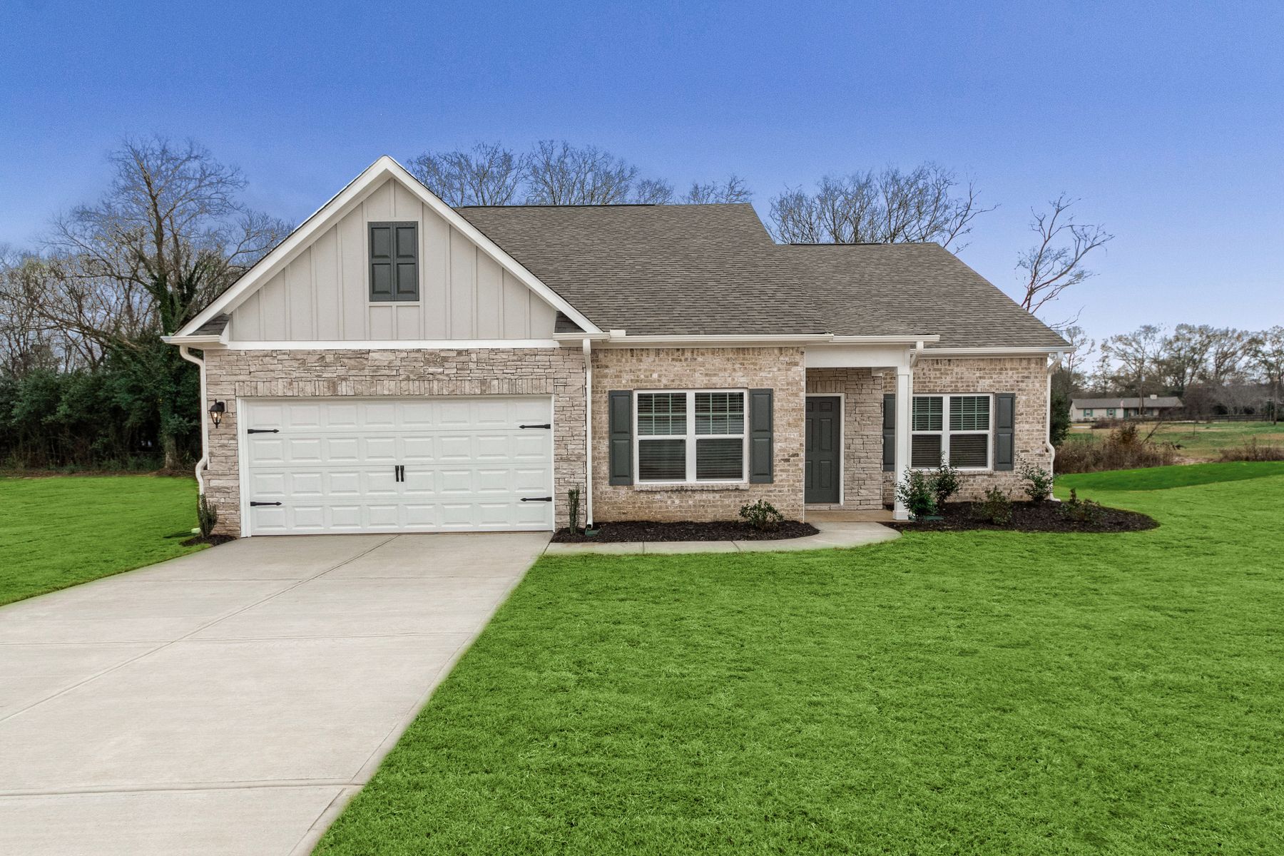 Exterior of the Dockery, showcasing stone and brick.:LGI Homes at Bunn Farms