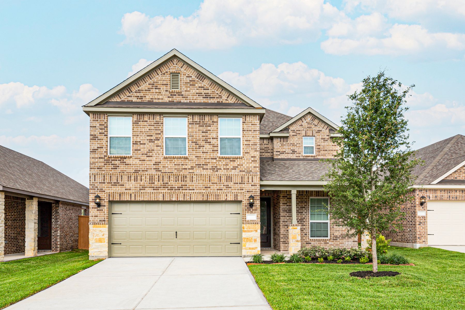 The Twinberry by LGI Homes:This beautiful two-story home has brick and stone and front yard landscaping!