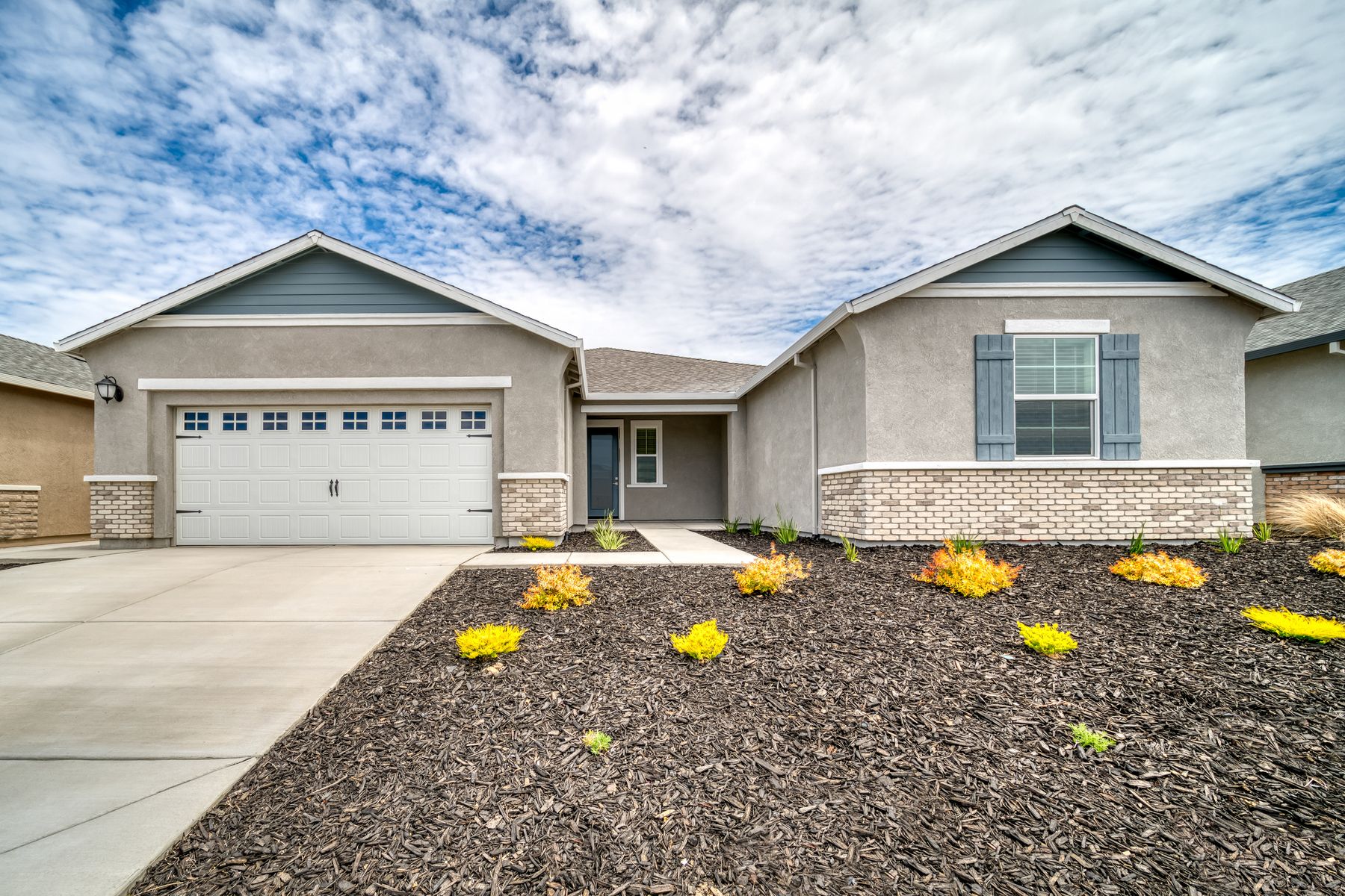 Exterior of the Roosevelt with professional landscaping and an inviting front porch.:Terrata Homes at Summit at Liberty