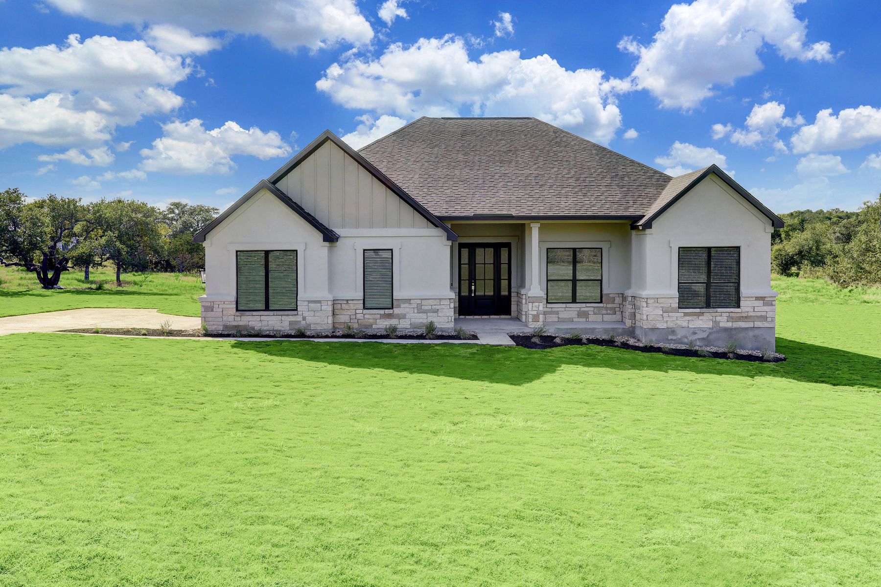 The Fairview plan is a spacious single story home with white stucco and tan stone accents.:Terrata Homes at Esperanza