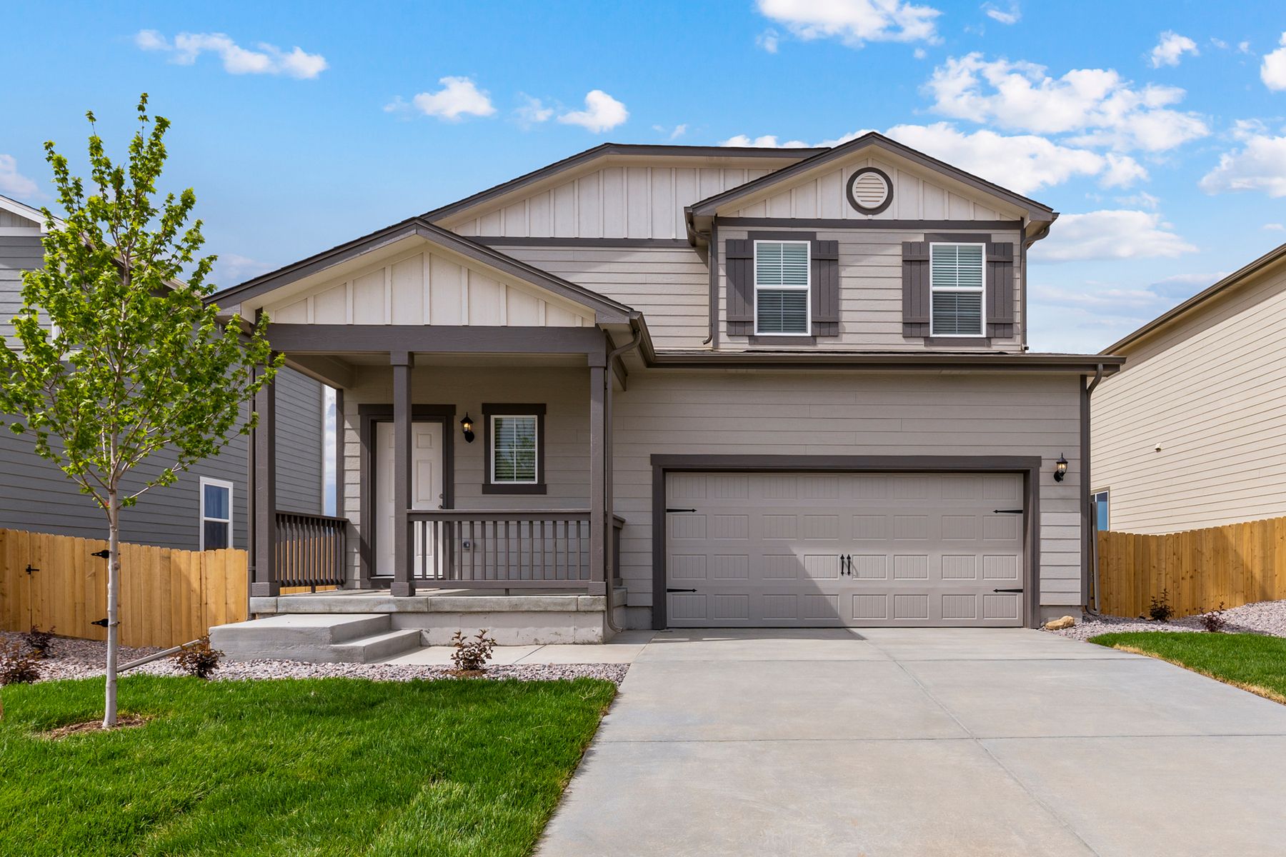 The St. Vrain floor plan has a covered front porch and two-car garage.:LGI Homes at Hidden Creek