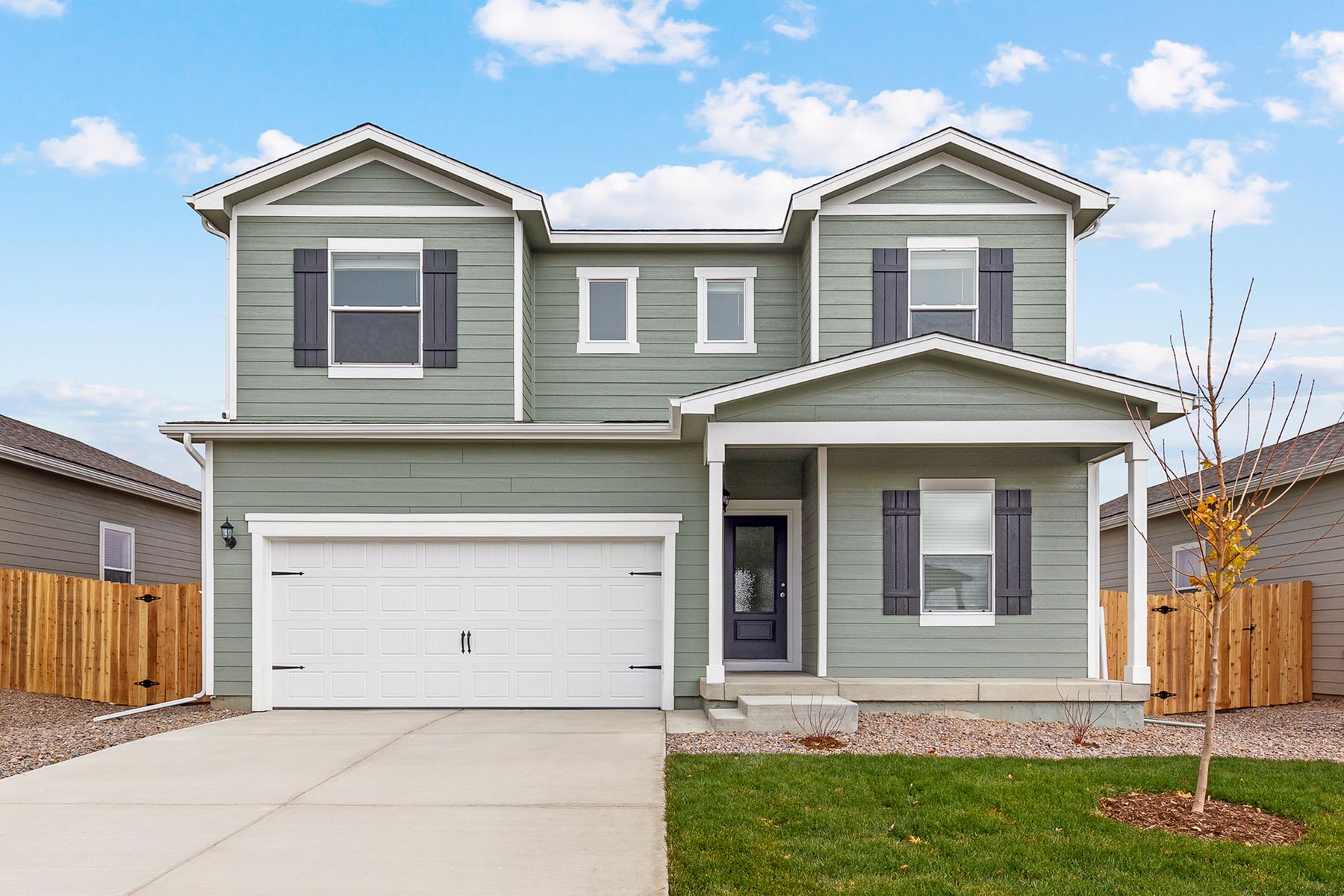 Exterior of the two-story Columbia with professional front yard landscaping.:LGI Homes at Cottonwood Greens