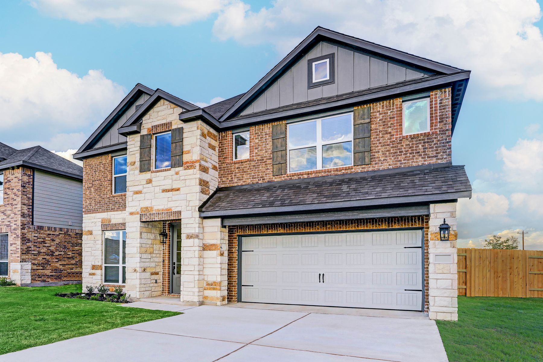 Angled exterior of the Sterling with stone and brick.:Terrata Homes at TRACE